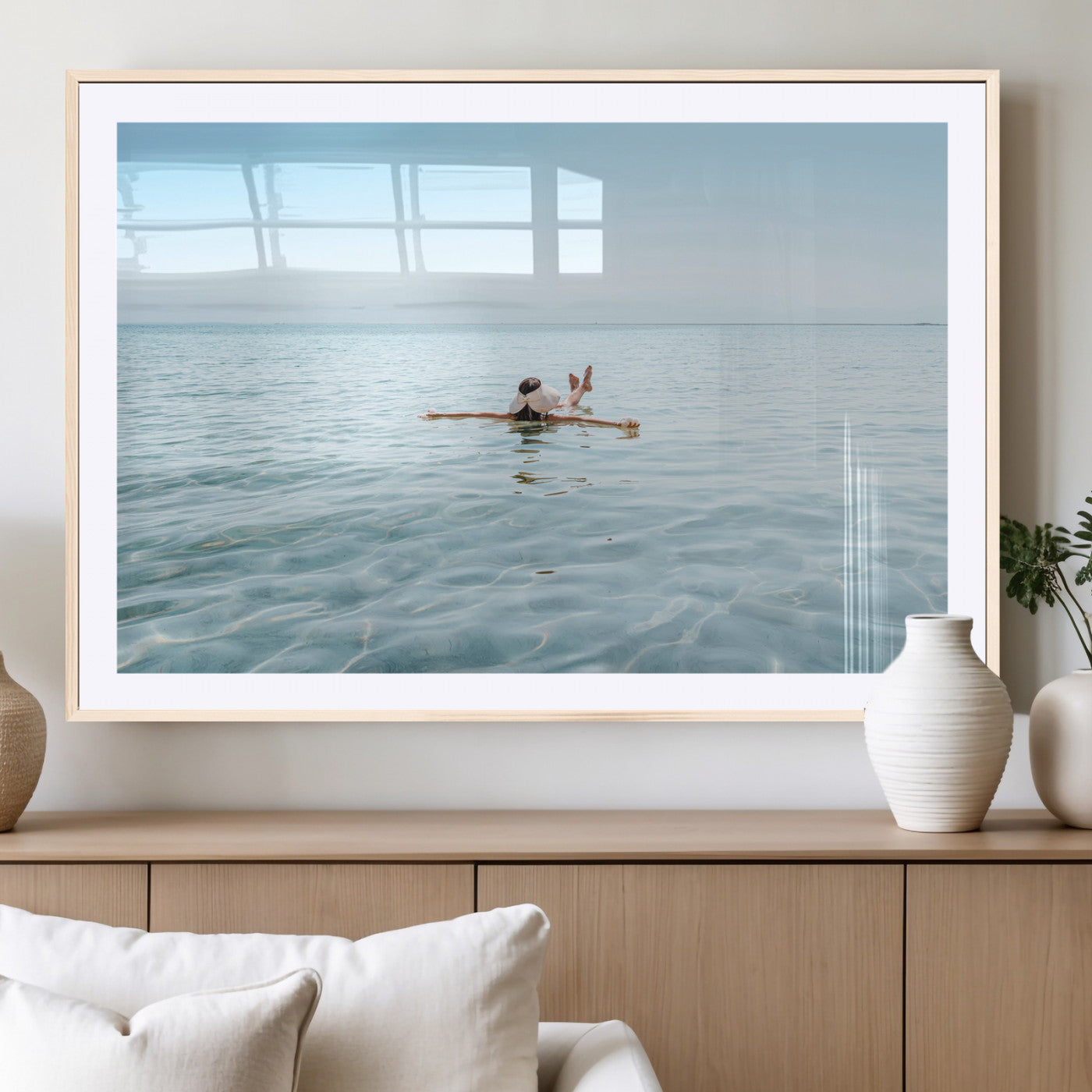 A peaceful minimalist scene of a person floating on crystal-clear water, surrounded by a vast open horizon, capturing relaxation and serenity in a tranquil aquatic setting.