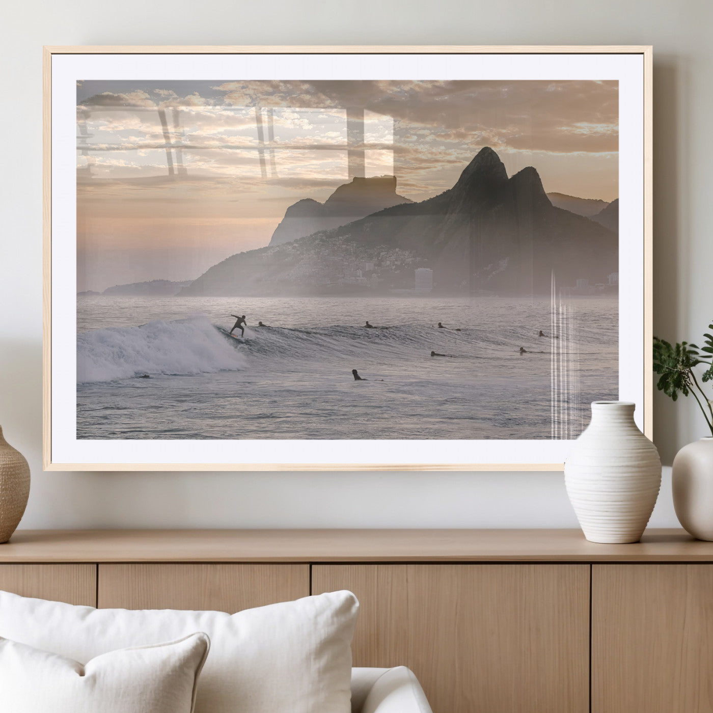 A surfer rides a golden hour wave near misty coastal mountains, surrounded by fellow surfers, capturing the spirit of a coastal adventure.
