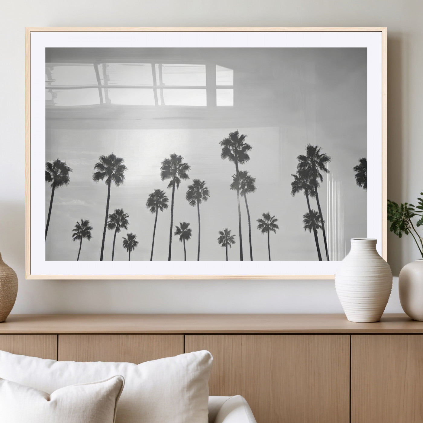 A black and white minimalist scene featuring tall palm trees silhouetted against a bright sky, creating a dreamy and timeless tropical aesthetic.