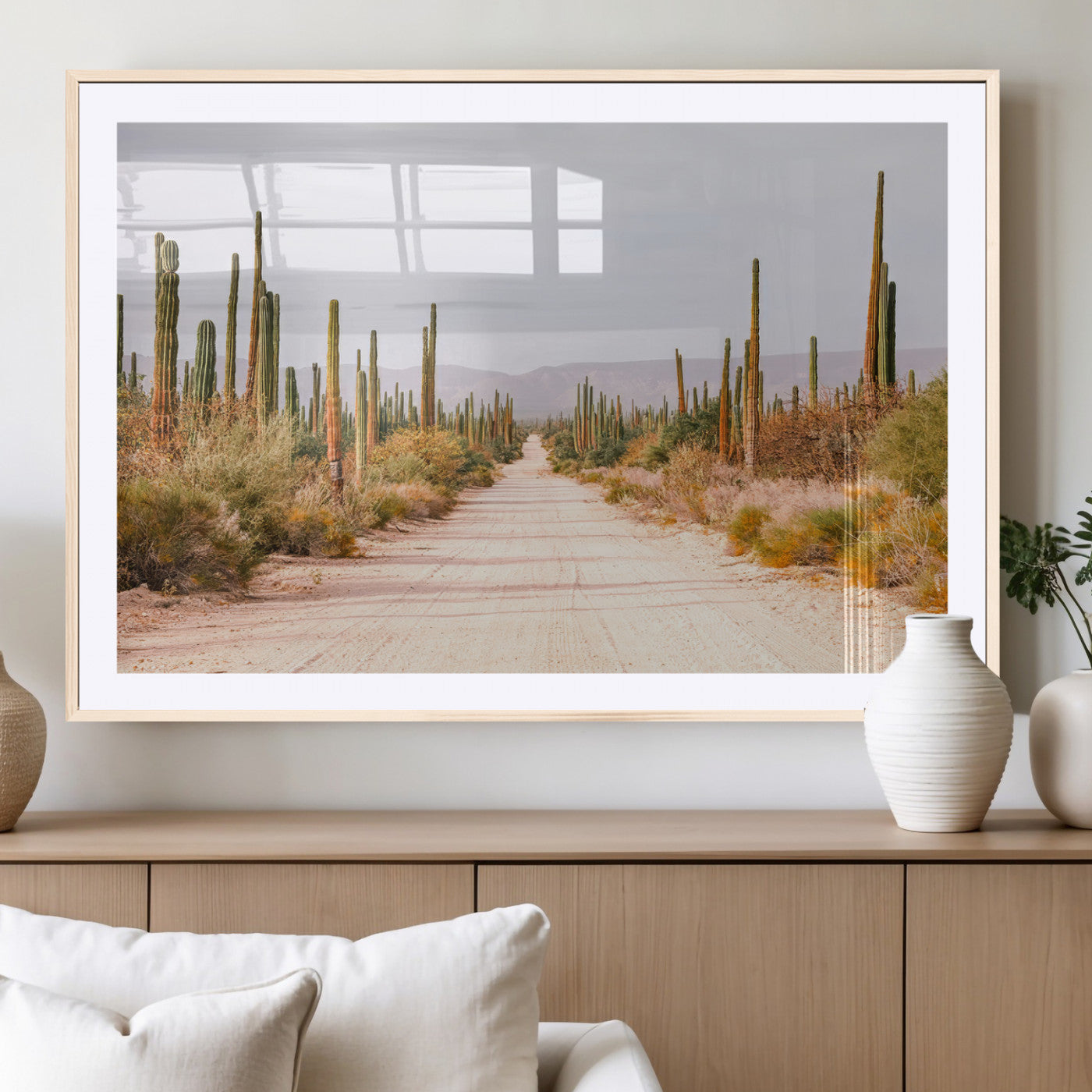 A desert road lined with saguaro cacti under a golden sky, creating a warm southwestern feel, perfect for boho or rustic decor.