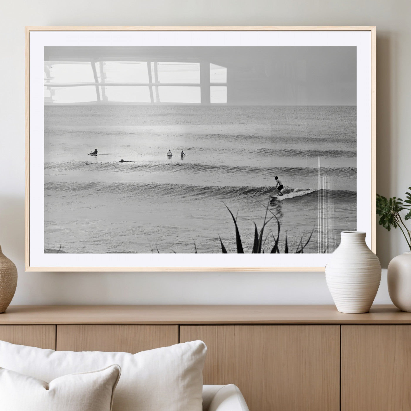 Monochrome canvas of surfers on calm ocean waves, ideal for minimalist coastal or beach-inspired interior decor.