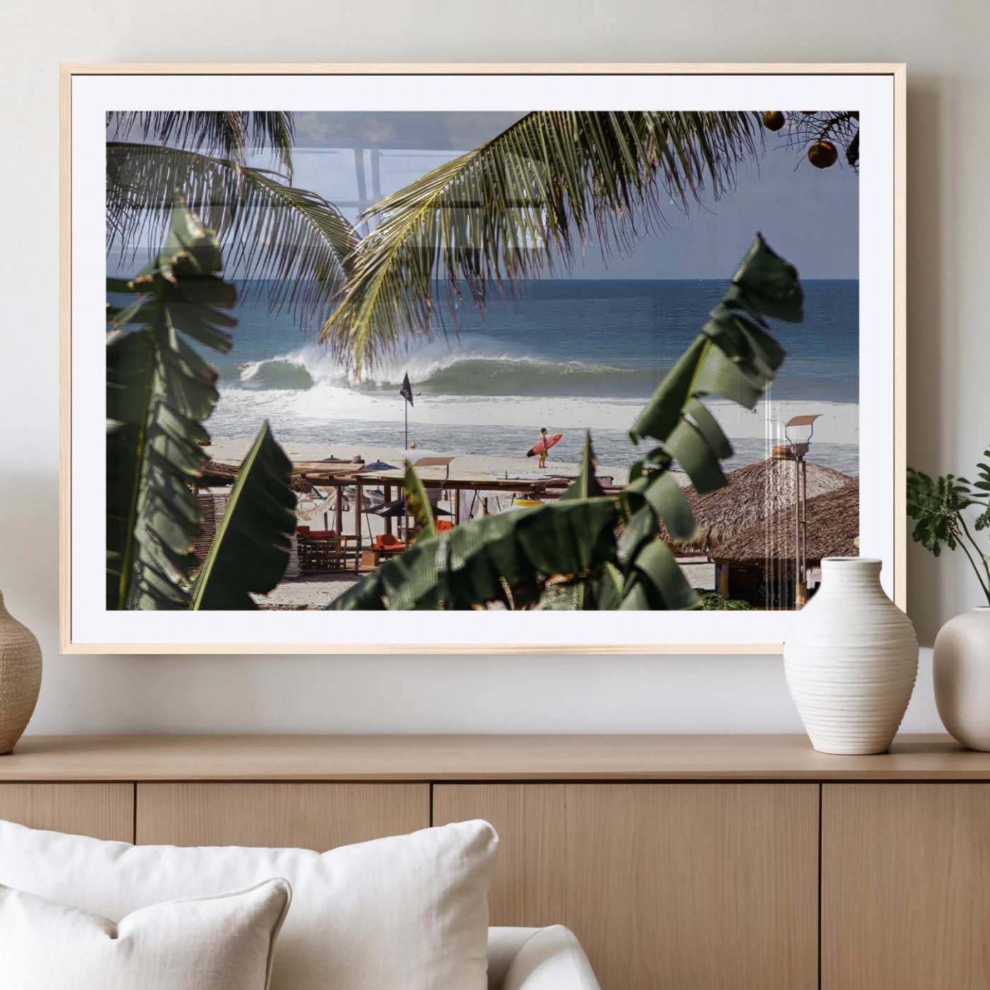 Canvas wall art of a tropical surf scene framed by palm trees, with a surfer on the shore and waves rolling in, ideal for beach-themed decor.