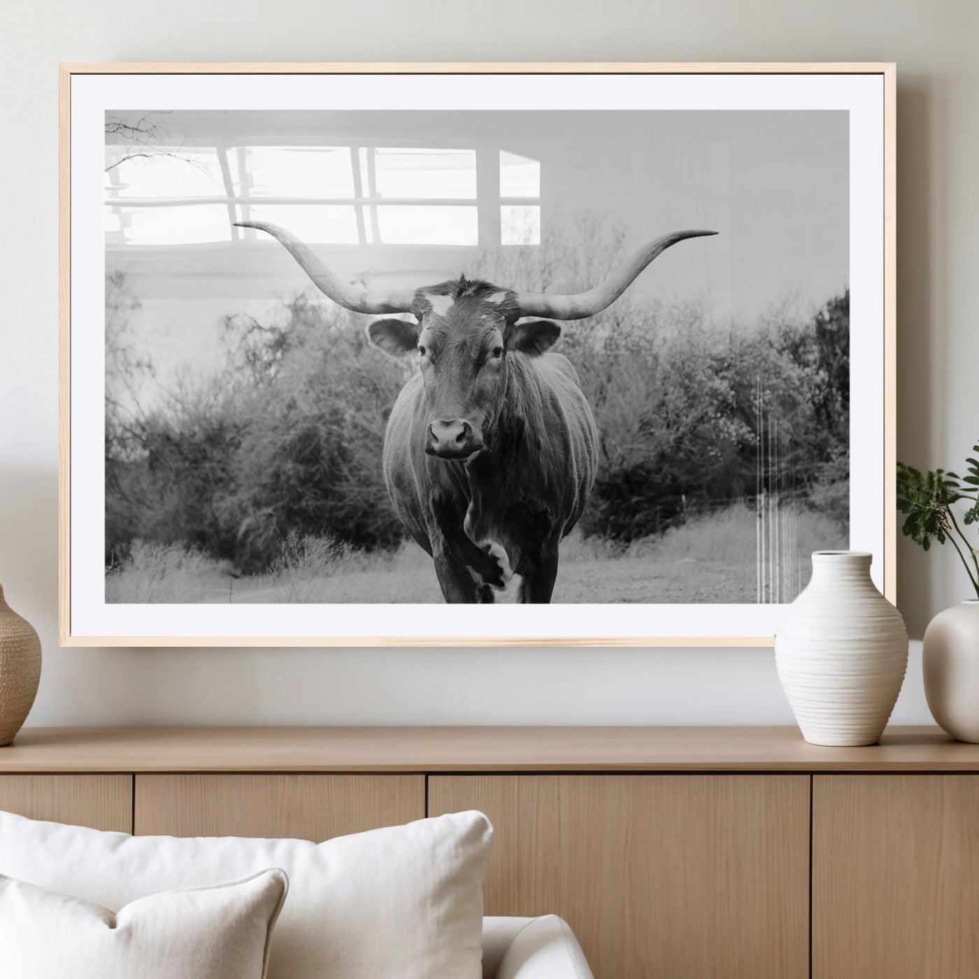 Black and white photo of a Longhorn cow facing camera, ideal for rustic, farmhouse, or western-themed home wall decor.
