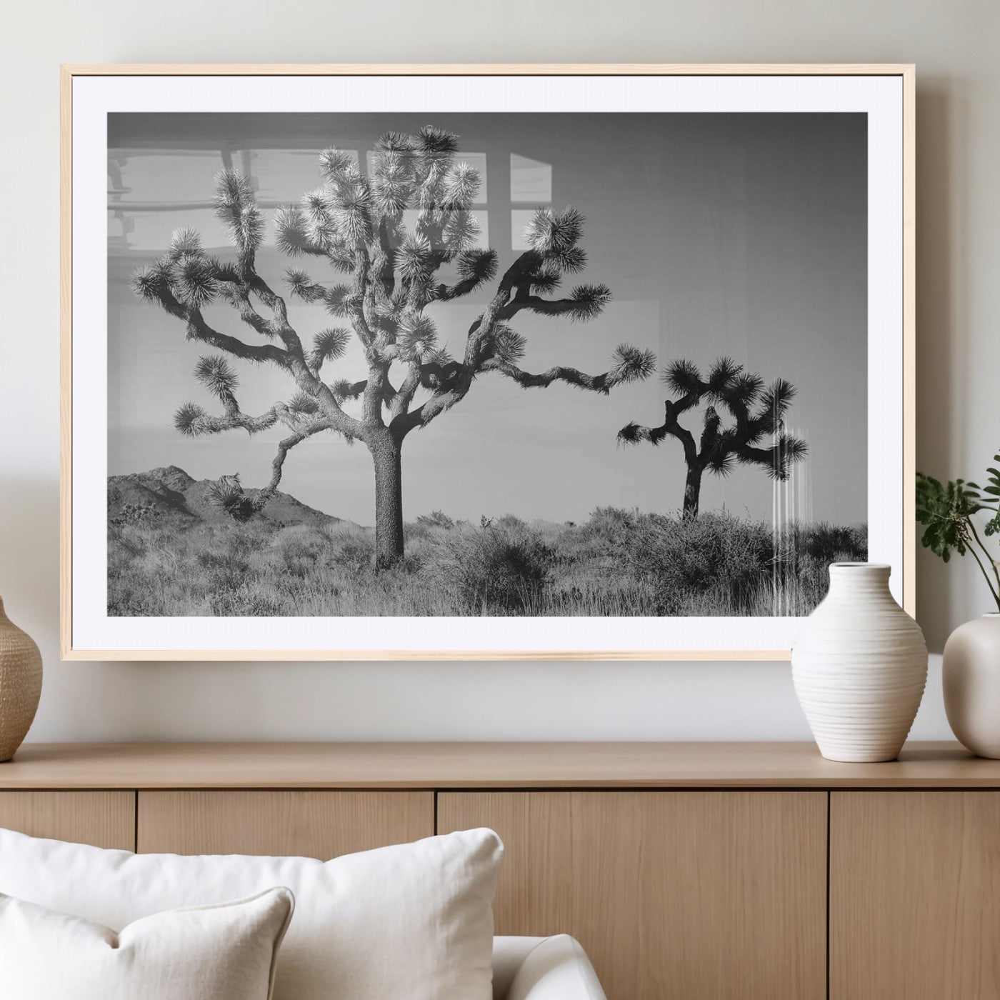 Black and white desert scene with two Joshua trees under clear sky, perfect for rustic or boho-inspired home decor.