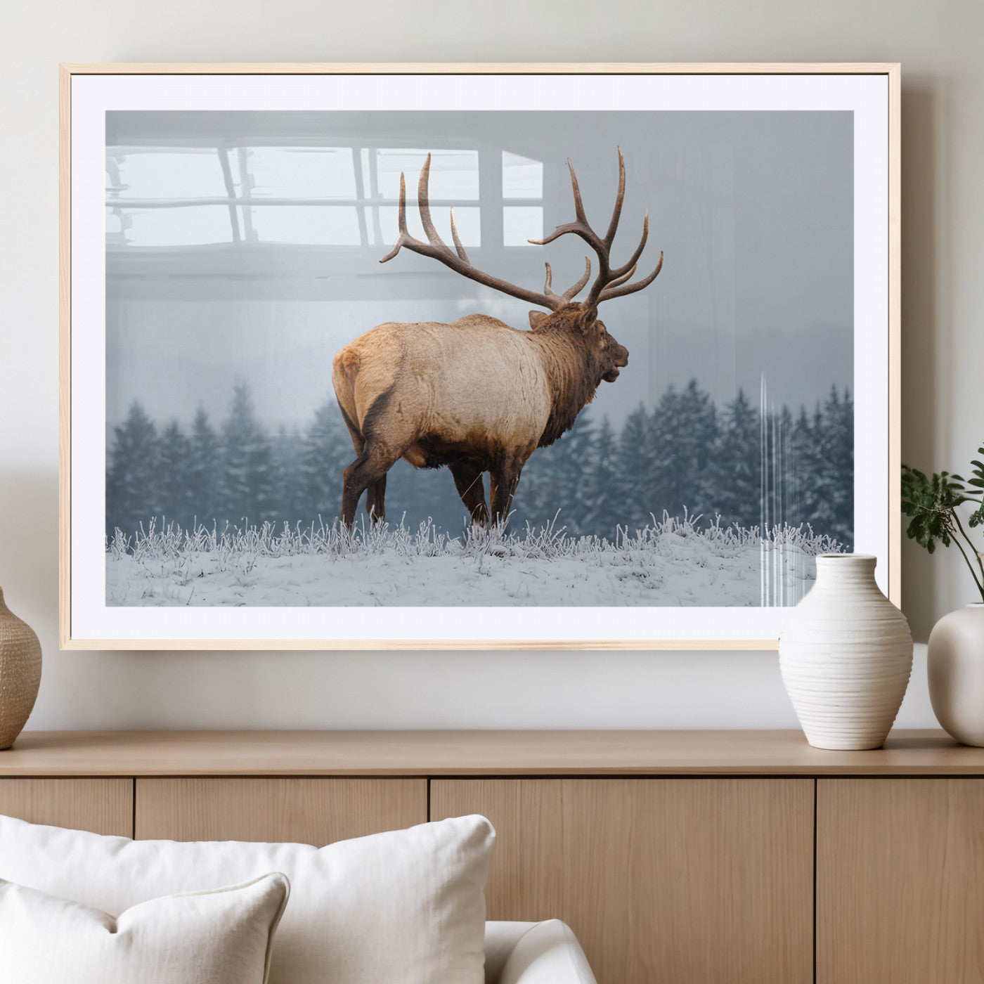 Large elk standing in a snowy field with pine trees in the background, ideal for rustic cabin or lodge-style wall decor.