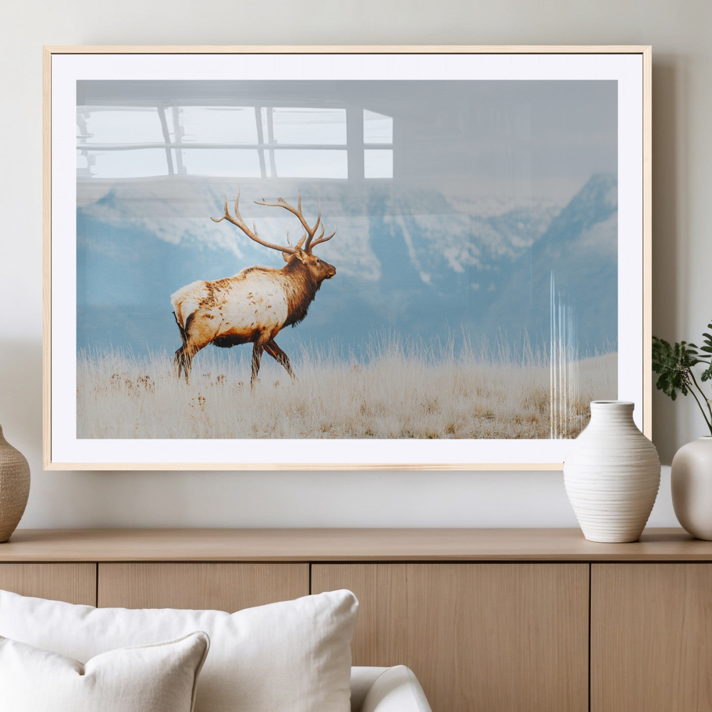 Majestic elk standing on dry grassland with snowy mountains in the background, ideal for rustic or lodge-inspired wall decor.