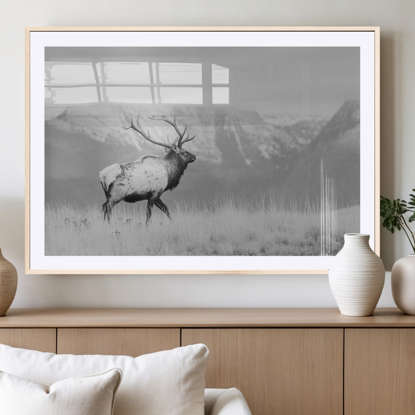 Black and white elk standing in front of snowy mountain range, perfect for rustic lodge or nature-inspired wall decor.