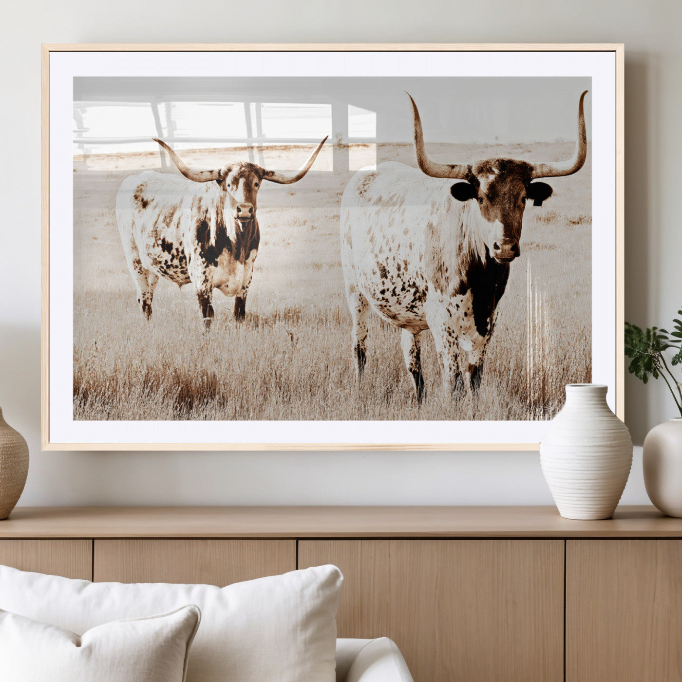 Two Texas longhorn cows standing in a sepia-toned pasture, evoking rustic charm perfect for farmhouse or western country interiors. (