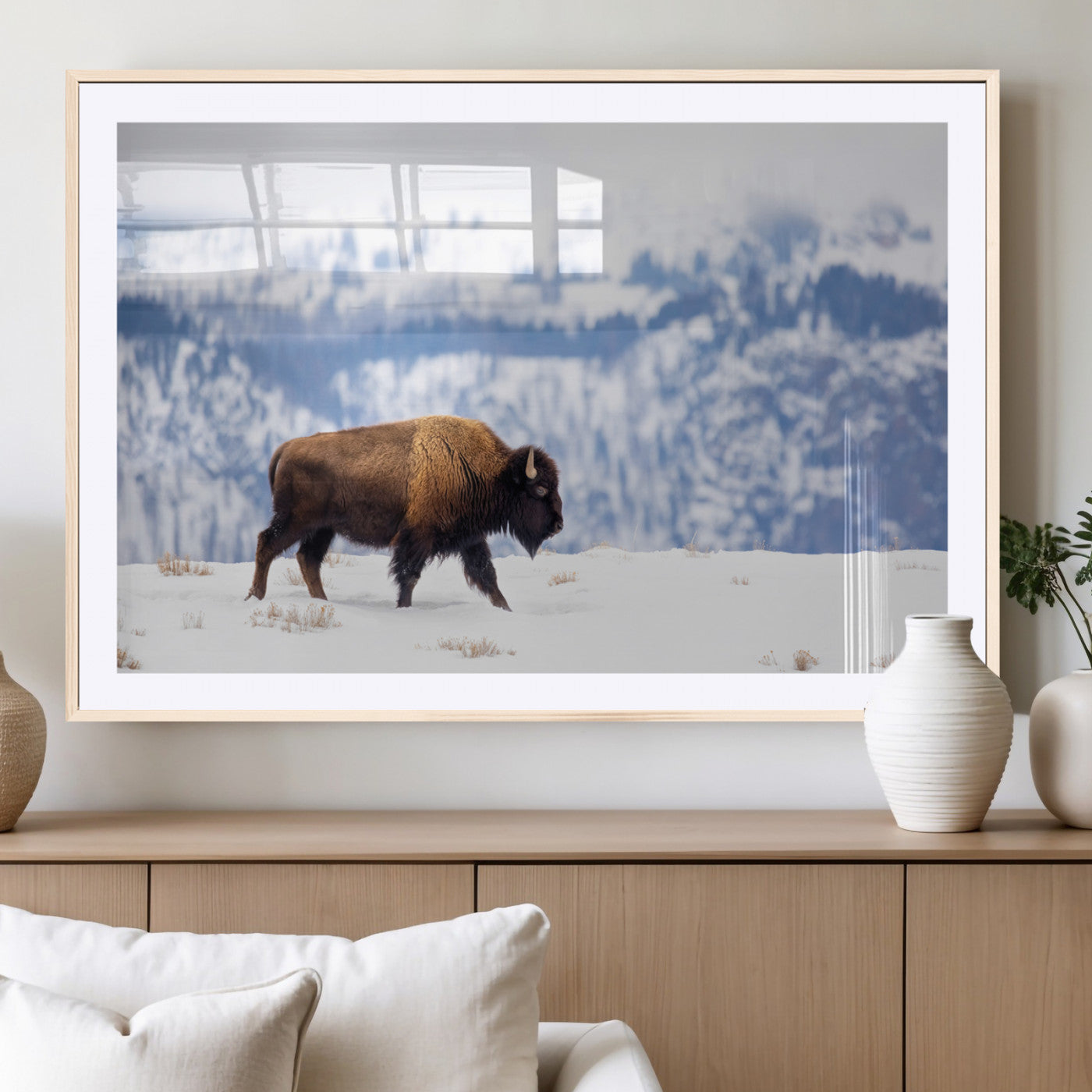 A lone bison walks across snowy ground with blue-toned mountain range behind, ideal for rustic or western farmhouse interiors.