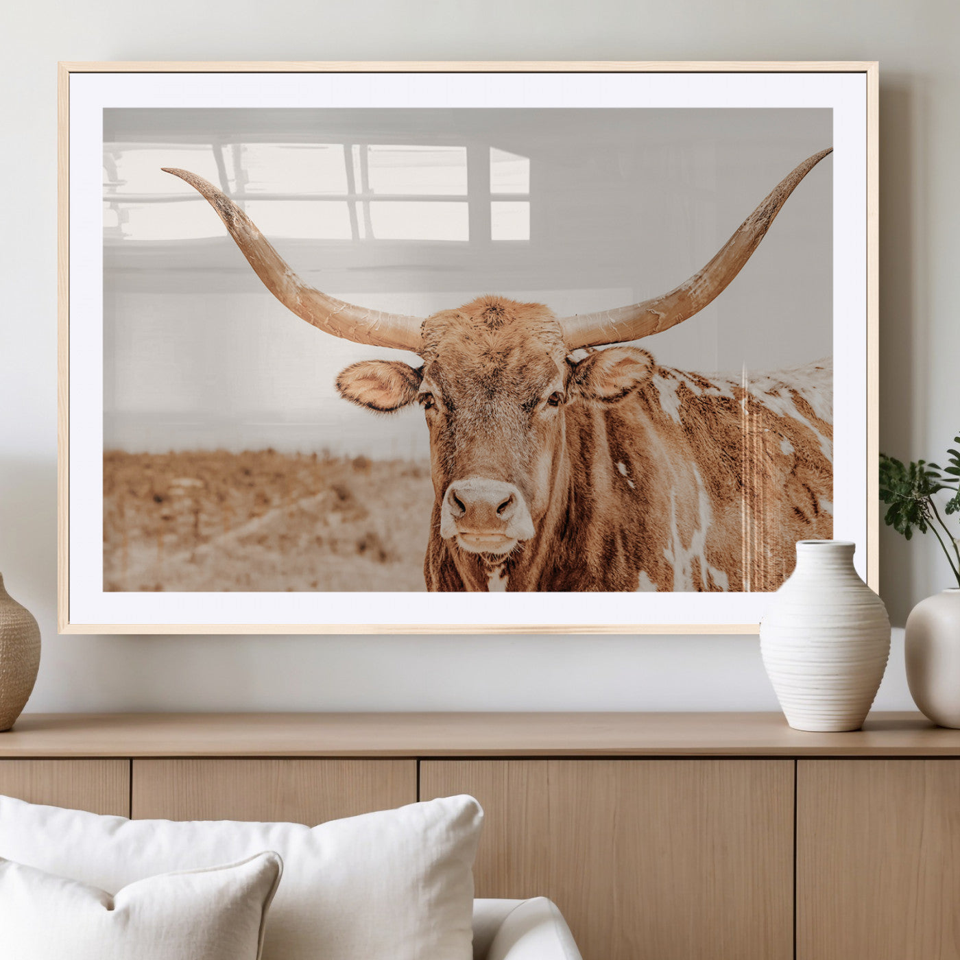 A longhorn bull standing proudly in a sunlit desert field with warm neutral tones, ideal for rustic western or farmhouse interiors.