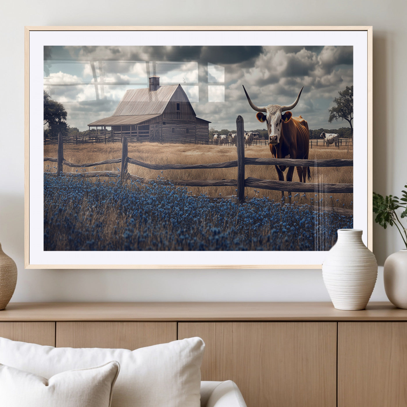 Framed canvas art of a Texas Longhorn cow near a rustic barn and bluebonnet field, ideal for country-style or farmhouse wall decor.