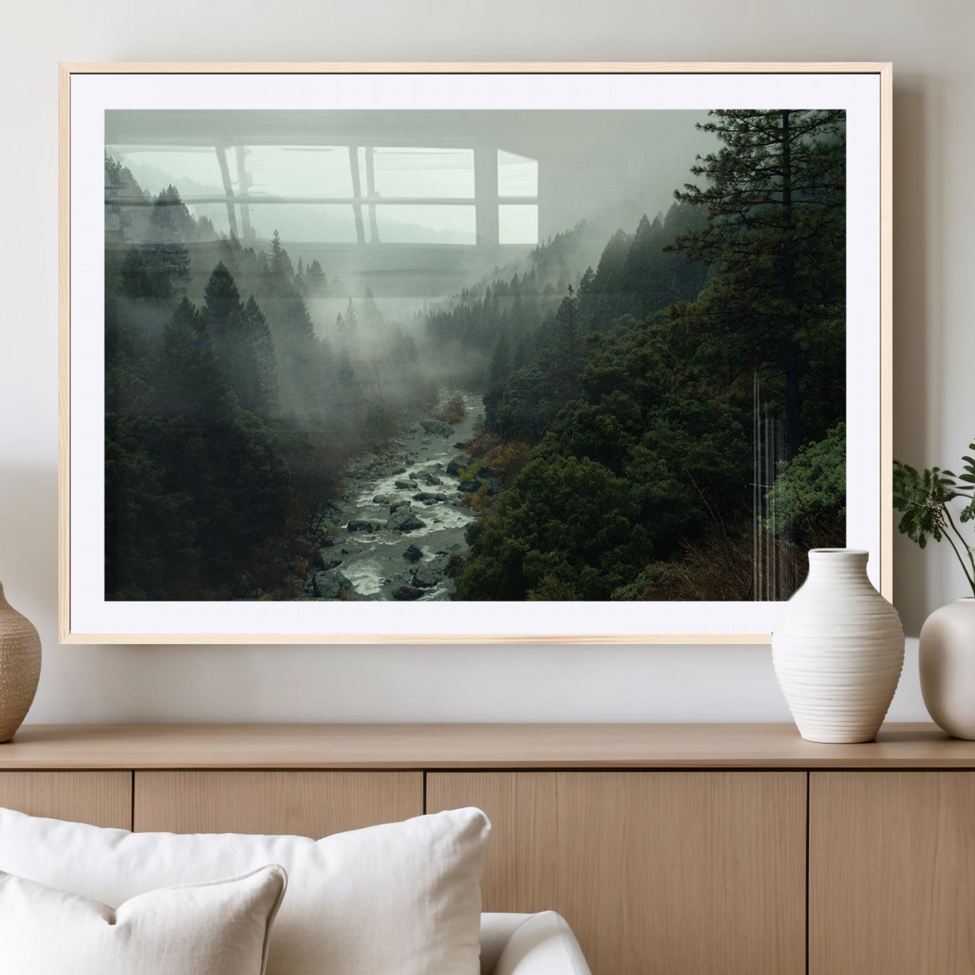 Misty forest with a winding river flowing through lush green mountains, creating a tranquil and moody wilderness landscape.