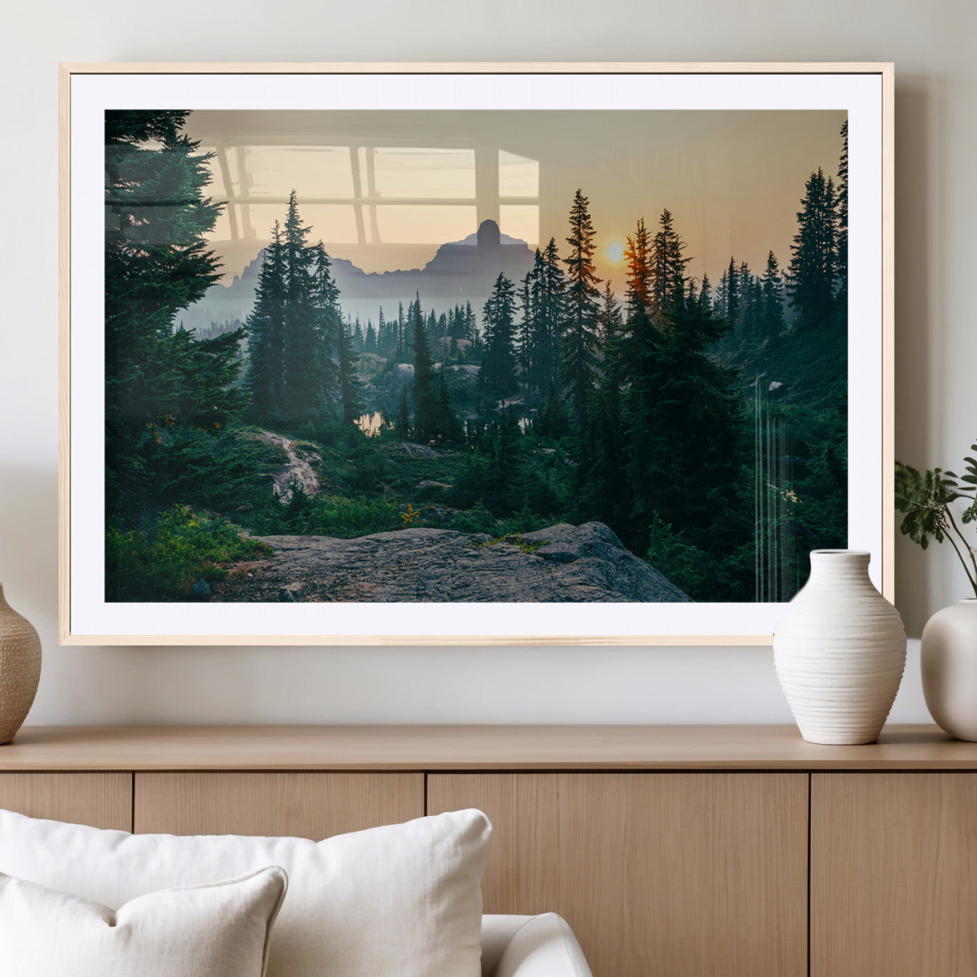 Mountain landscape with evergreen trees at sunset, casting a golden glow over the wilderness, creating a peaceful and rustic nature scene.