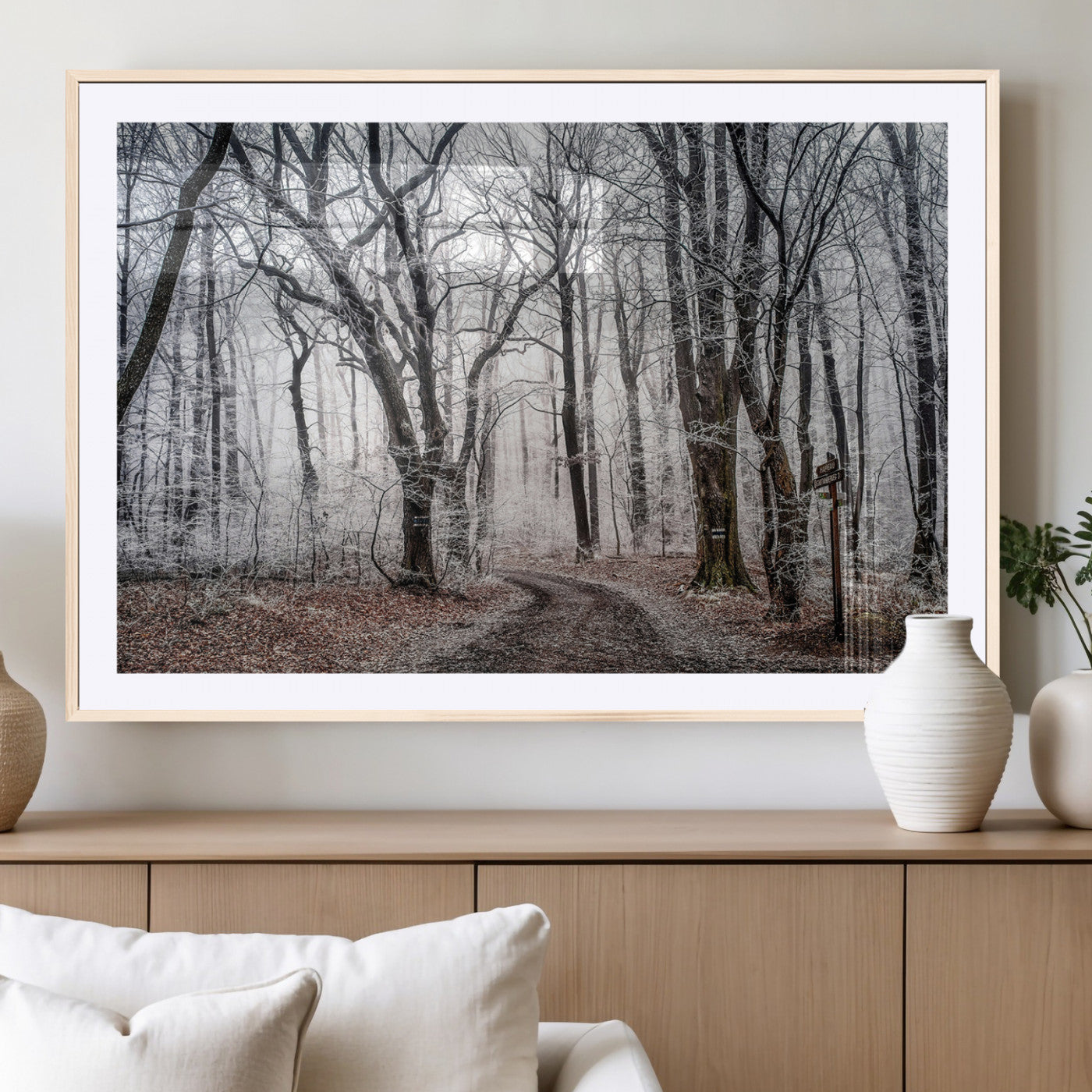 Snow-covered trees in a misty winter forest with a winding path, creating a serene and mysterious atmosphere, perfect for nature-inspired wall art.