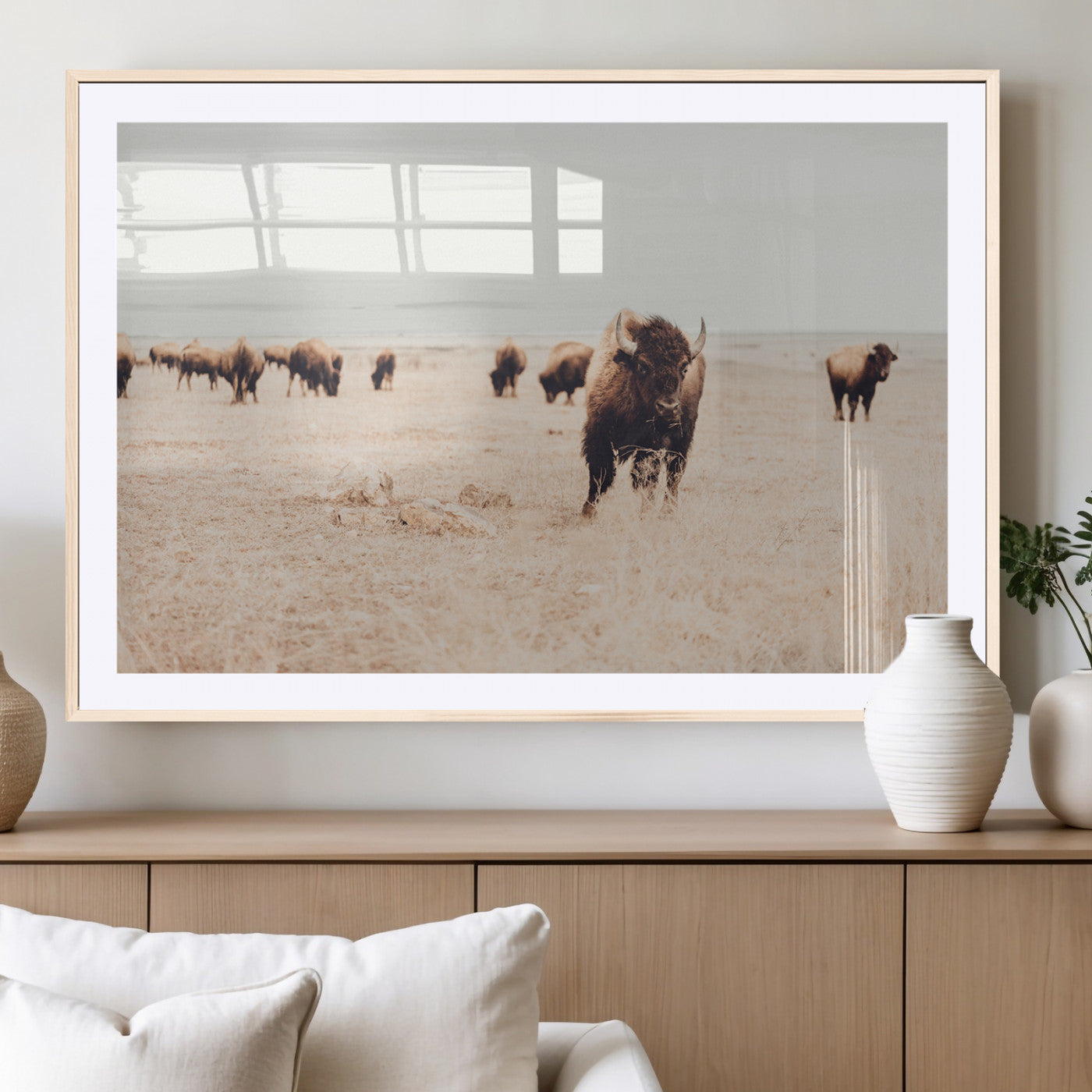 Herd of bison roaming a vast prairie with golden grass under a soft sky, creating a rustic and Western landscape, ideal for wall art.