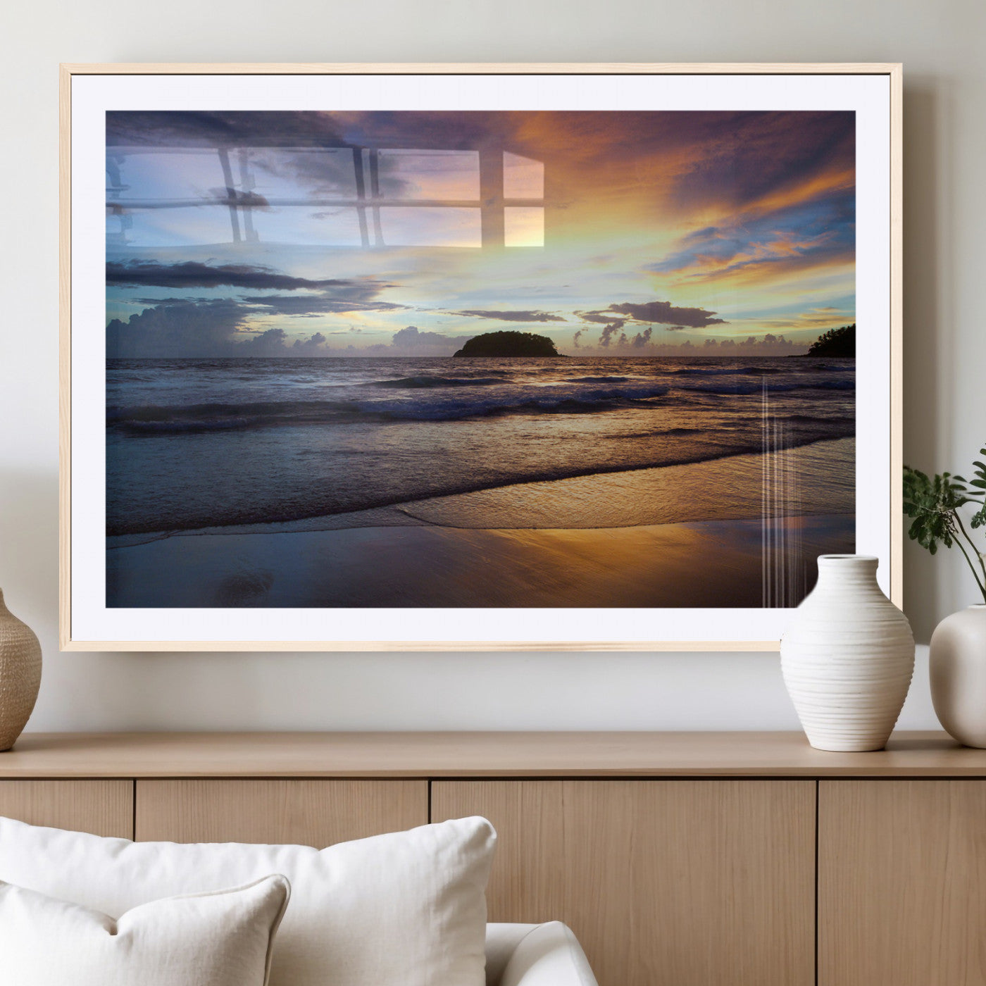 A tropical beach at sunset with waves gently washing ashore, reflecting golden and purple hues in the sky, creating a tranquil coastal scene.