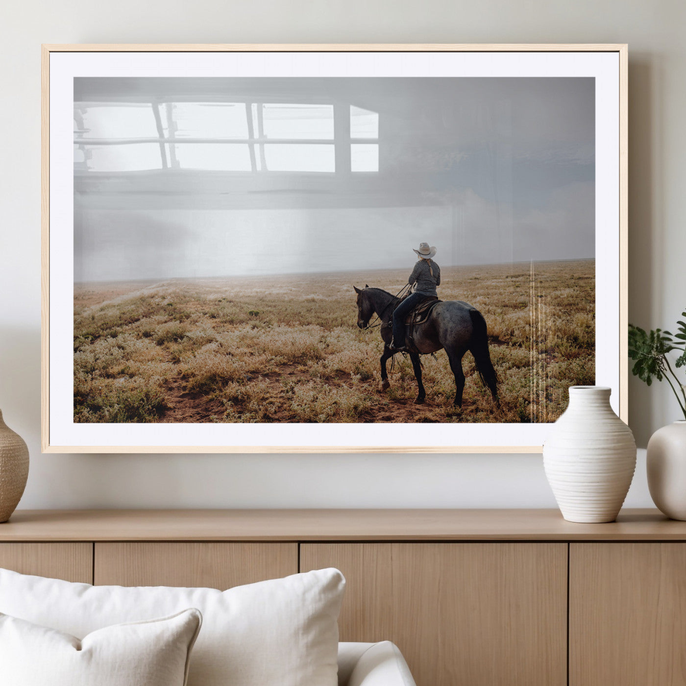 A lone cowboy riding horseback across an open prairie under a vast sky, capturing the rugged and timeless spirit of the Western frontier.