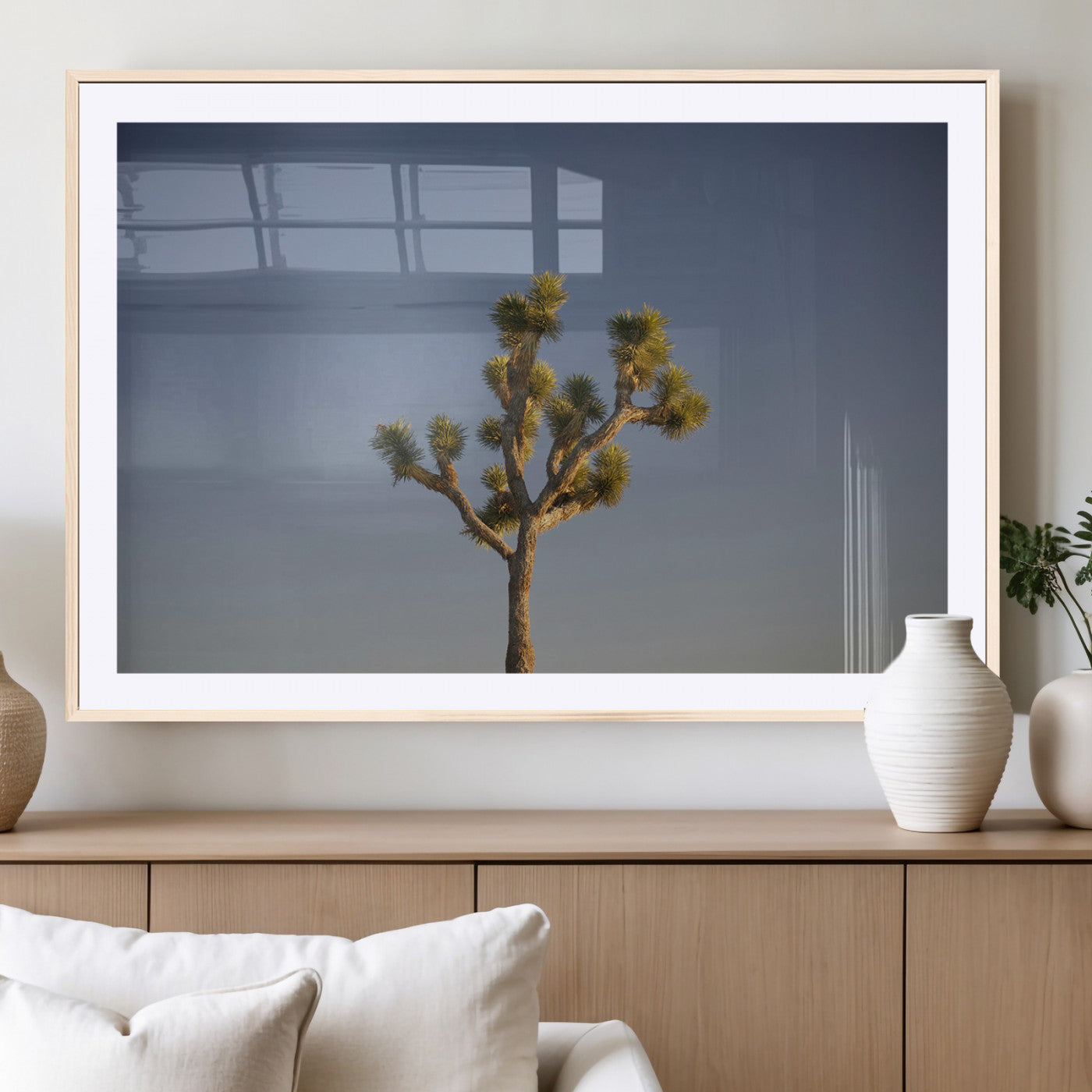A lone Joshua Tree standing against a deep blue sky, capturing the serene and rugged beauty of the Southwestern desert landscape.