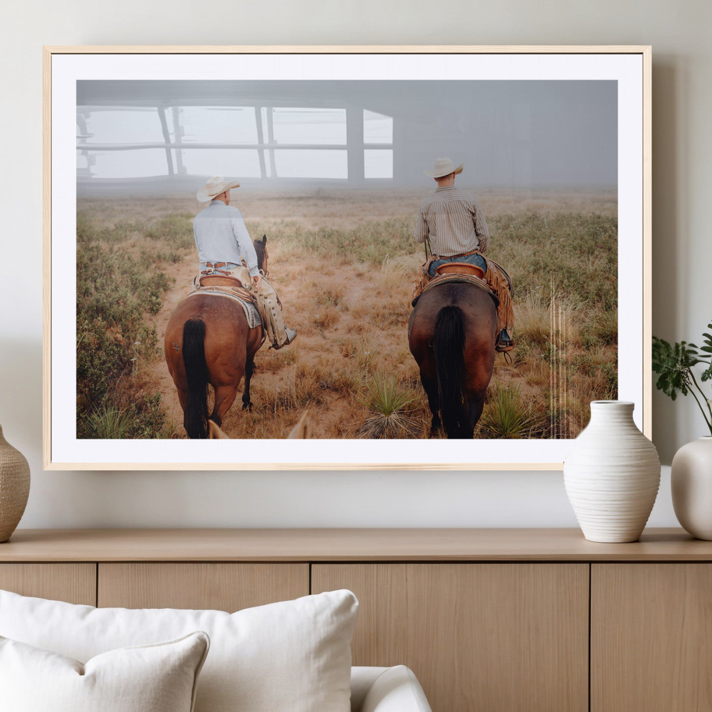 Two cowboys riding horseback through a misty prairie, capturing the rustic and adventurous spirit of the Western frontier.