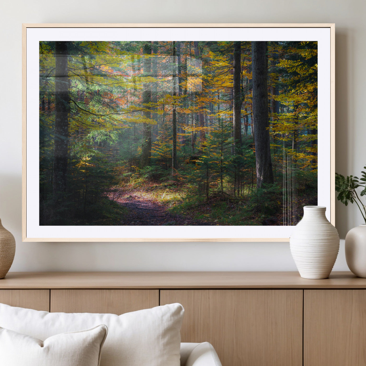 A serene autumn forest with golden and green leaves, a misty atmosphere, and a sunlit pathway, creating a tranquil nature-inspired wall art piece.