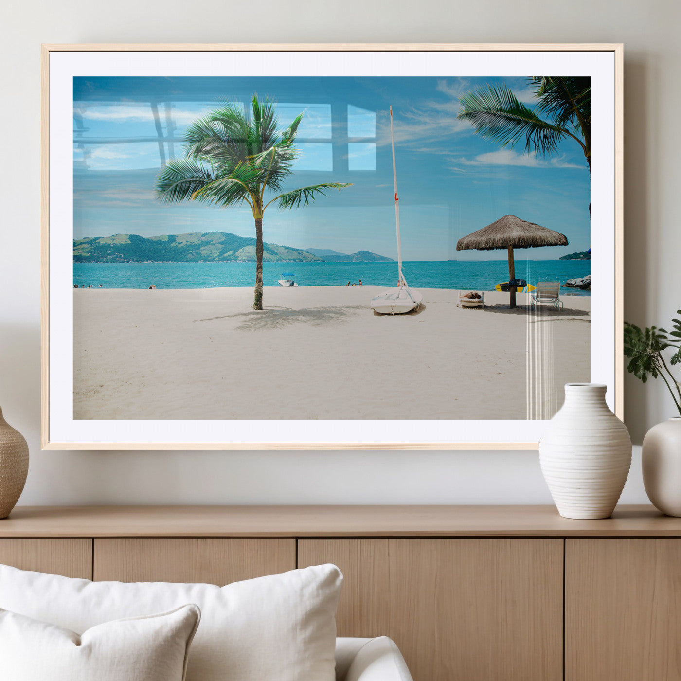 Tropical beach scene with palm trees, a white sailboat, and turquoise ocean waters under a bright blue sky, creating a peaceful summer vibe.
