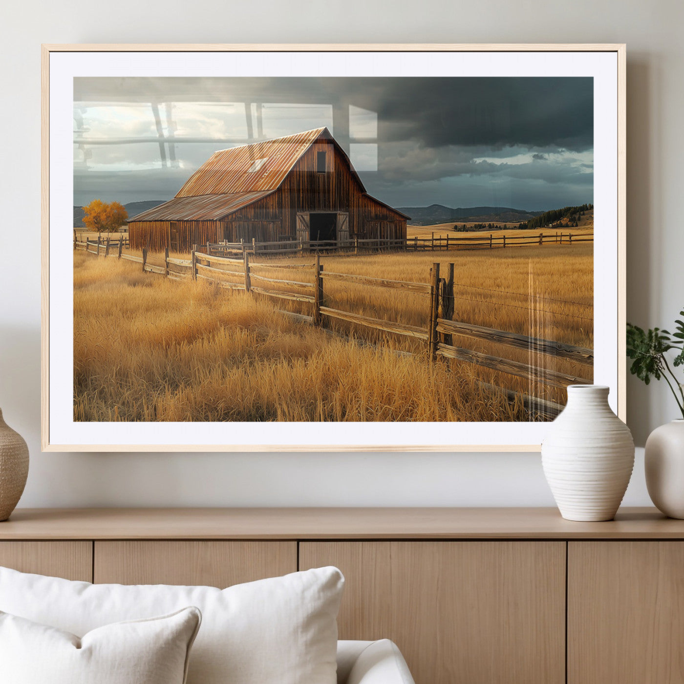 "Golden fields surrounding a rustic barn with a weathered roof, a wooden fence, and dramatic skies with sunlight breaking through the clouds."