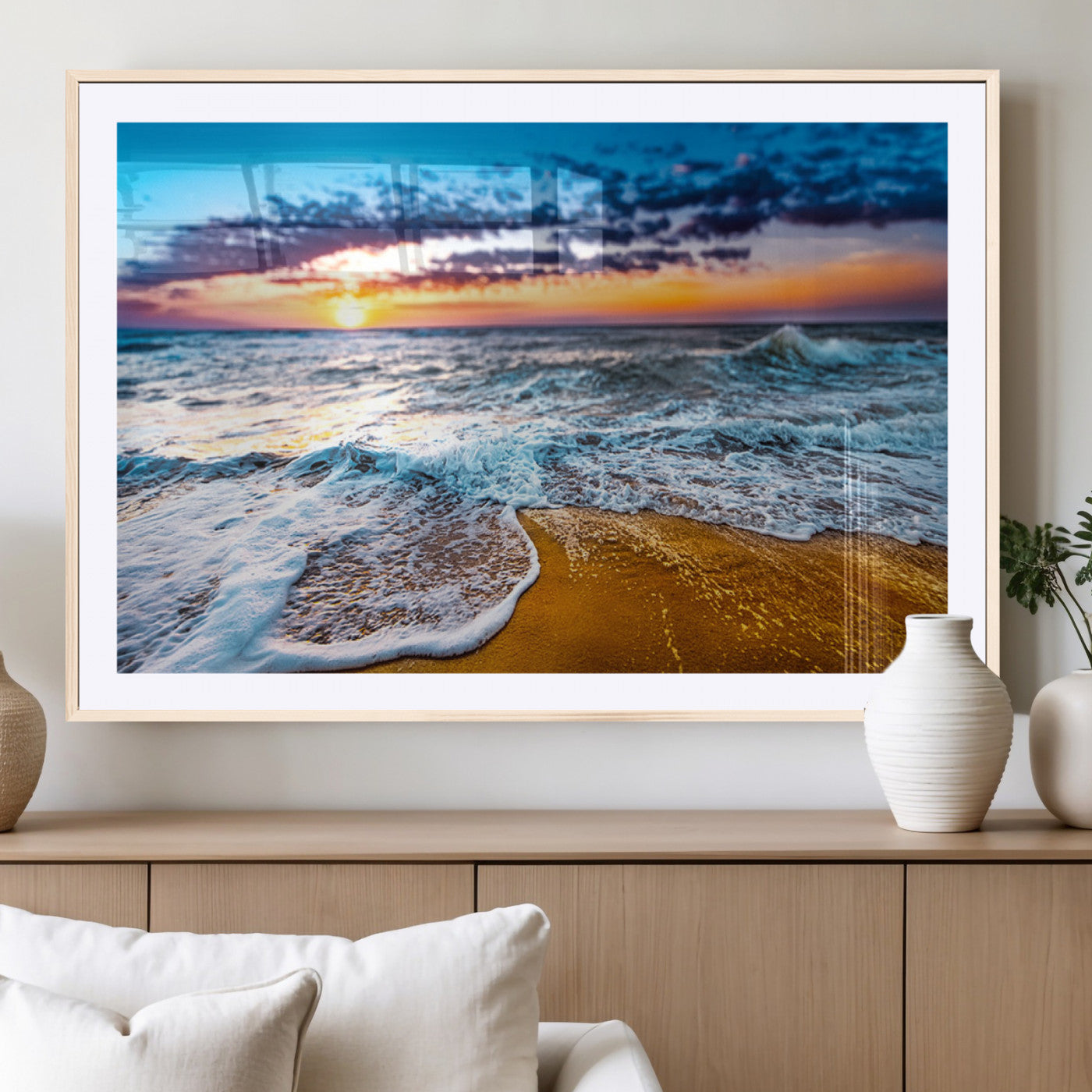 Beautiful ocean shoreline at sunset with foamy waves washing onto golden sand under a colorful sky – Wall Art Canvas Print.