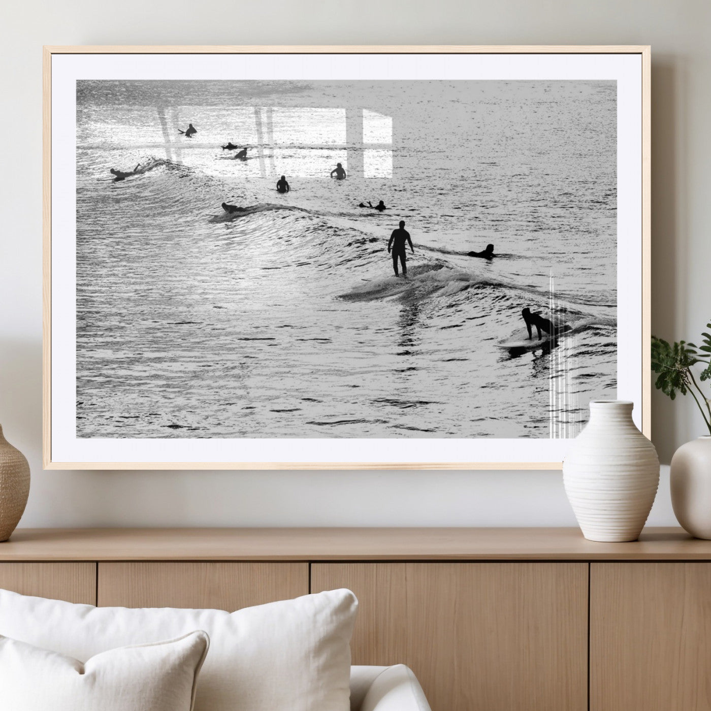 19970637-MGC-FP-40x30_Natural-Black and white artistic view of surfers riding and paddling on waves in the ocean, capturing the dynamic motion and energy of surfing