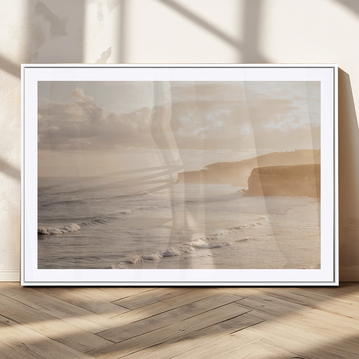 Golden hour seascape with misty cliffs and gentle waves rolling towards the shore, capturing a tranquil and warm coastal atmosphere.