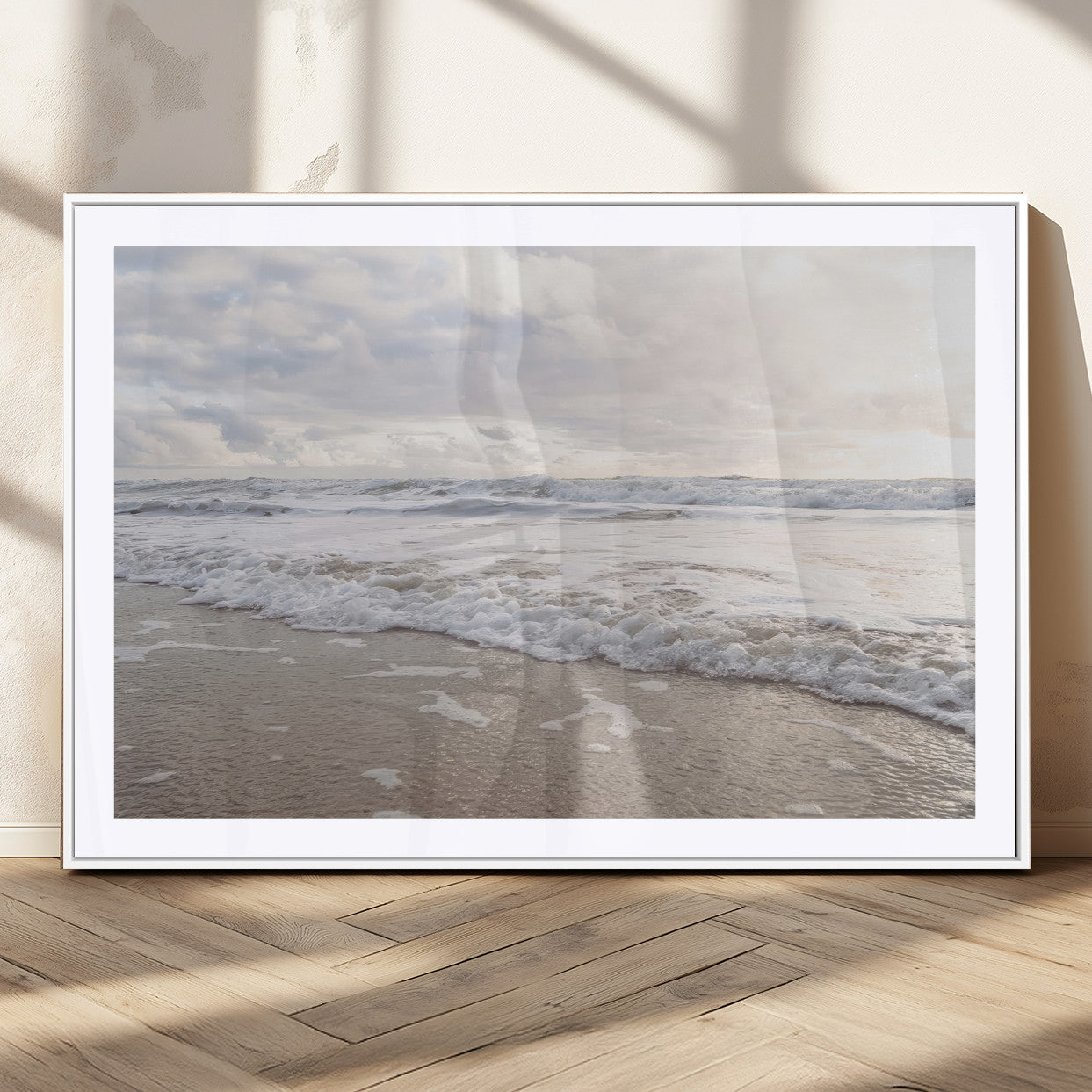 Peaceful ocean waves rolling onto the sandy shore under soft light, perfect for neutral or coastal minimalist decor themes.