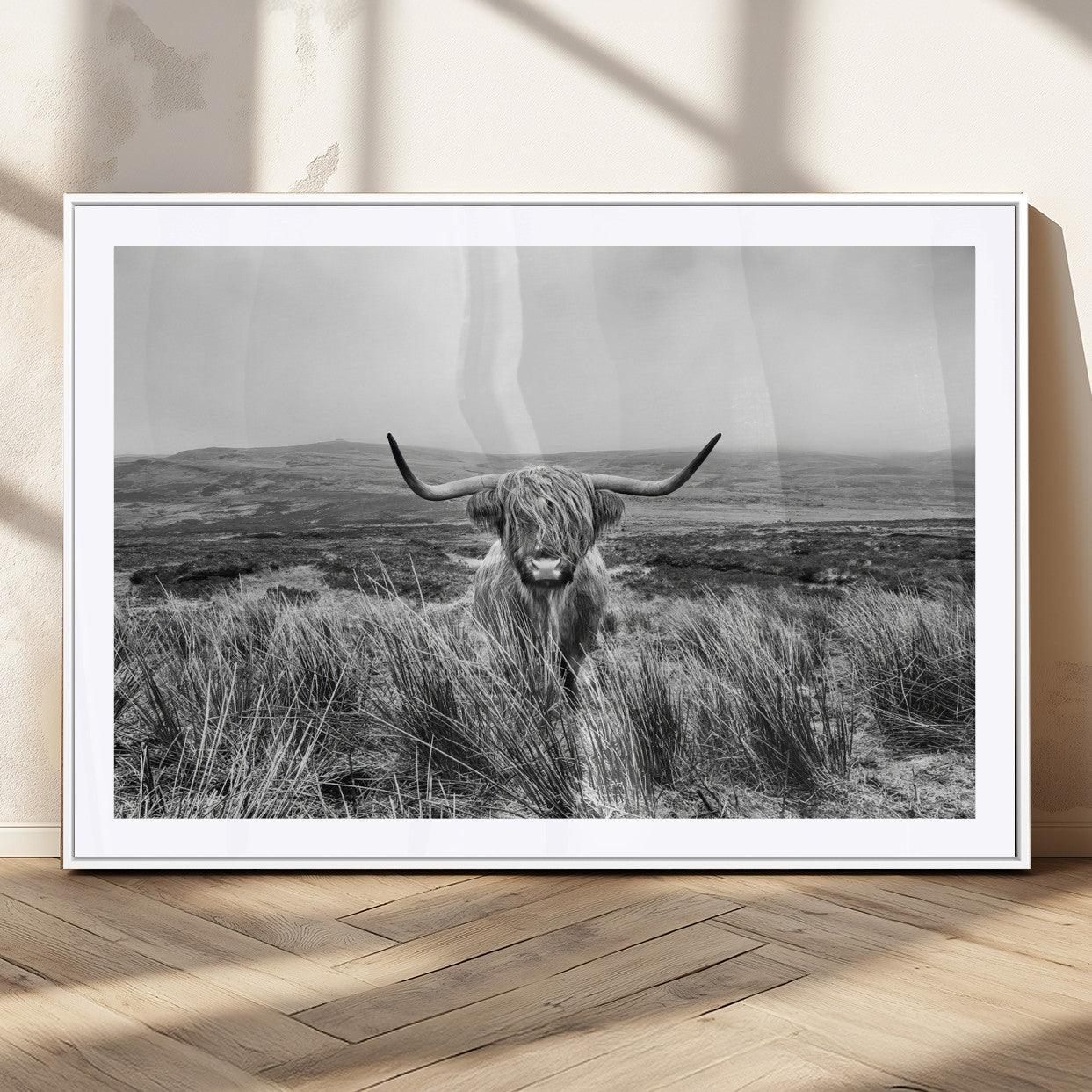 A black and white portrait of a Highland cow in a foggy Scottish countryside, capturing a rustic aesthetic and tranquil farm escape.