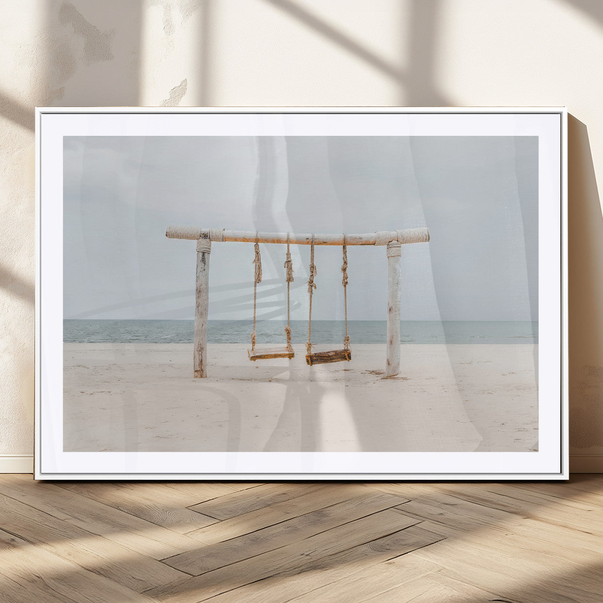 A rustic wooden beach swing stands on a serene sandy shore with an ocean horizon in the background, creating a tranquil and dreamy coastal escape.