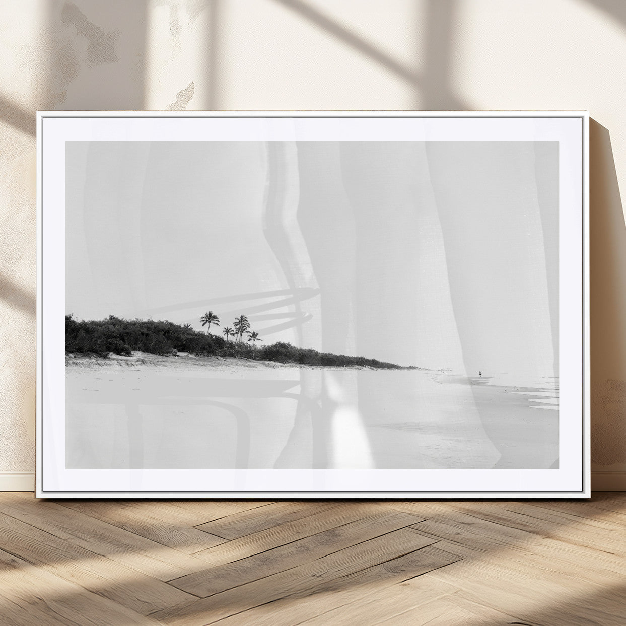 A black and white minimalist coastal scene with a vast open beach, distant palm trees, and a lone figure walking along the shoreline, evoking serenity and solitude.