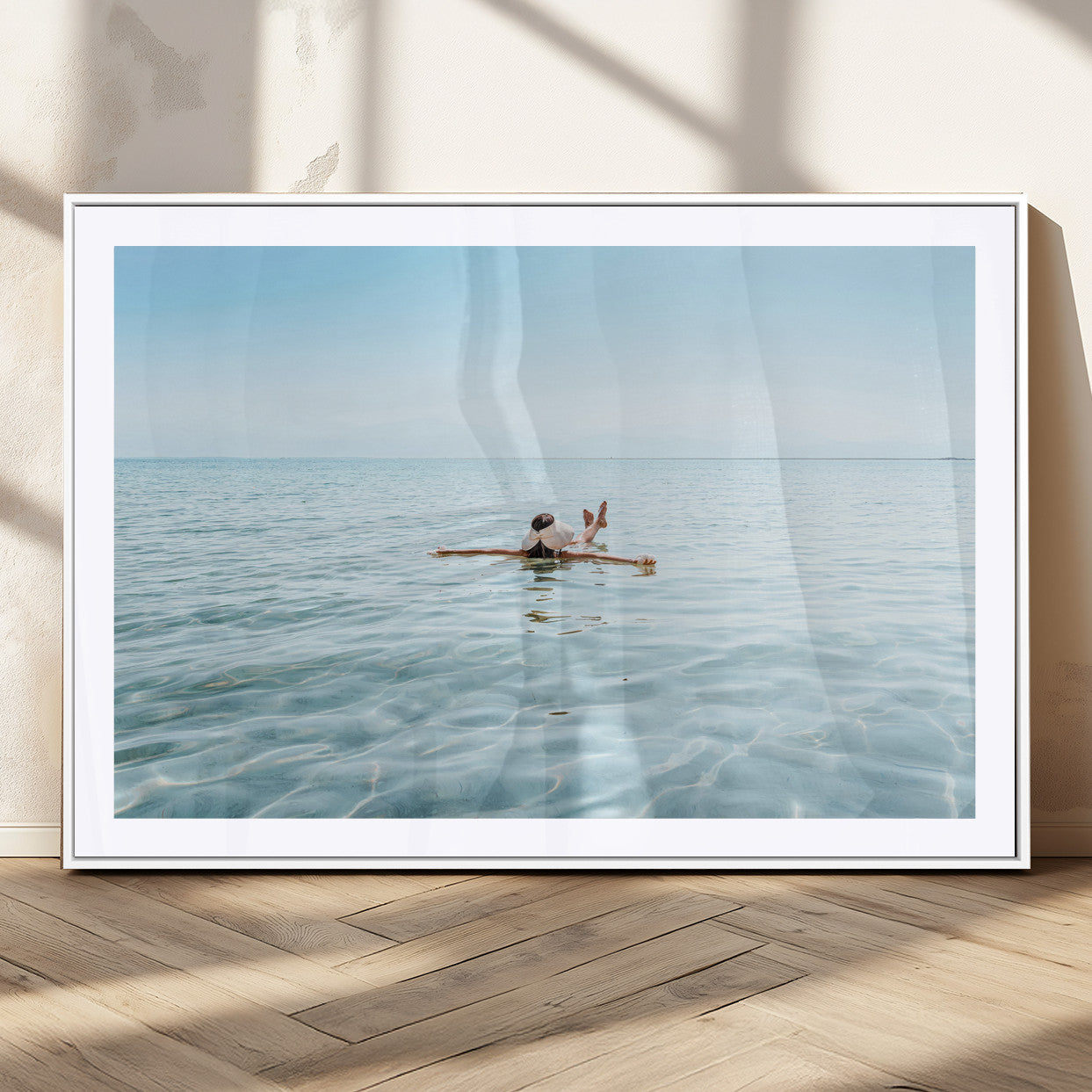 A peaceful minimalist scene of a person floating on crystal-clear water, surrounded by a vast open horizon, capturing relaxation and serenity in a tranquil aquatic setting.