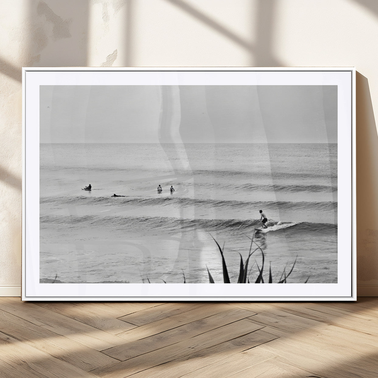 Monochrome canvas of surfers on calm ocean waves, ideal for minimalist coastal or beach-inspired interior decor.