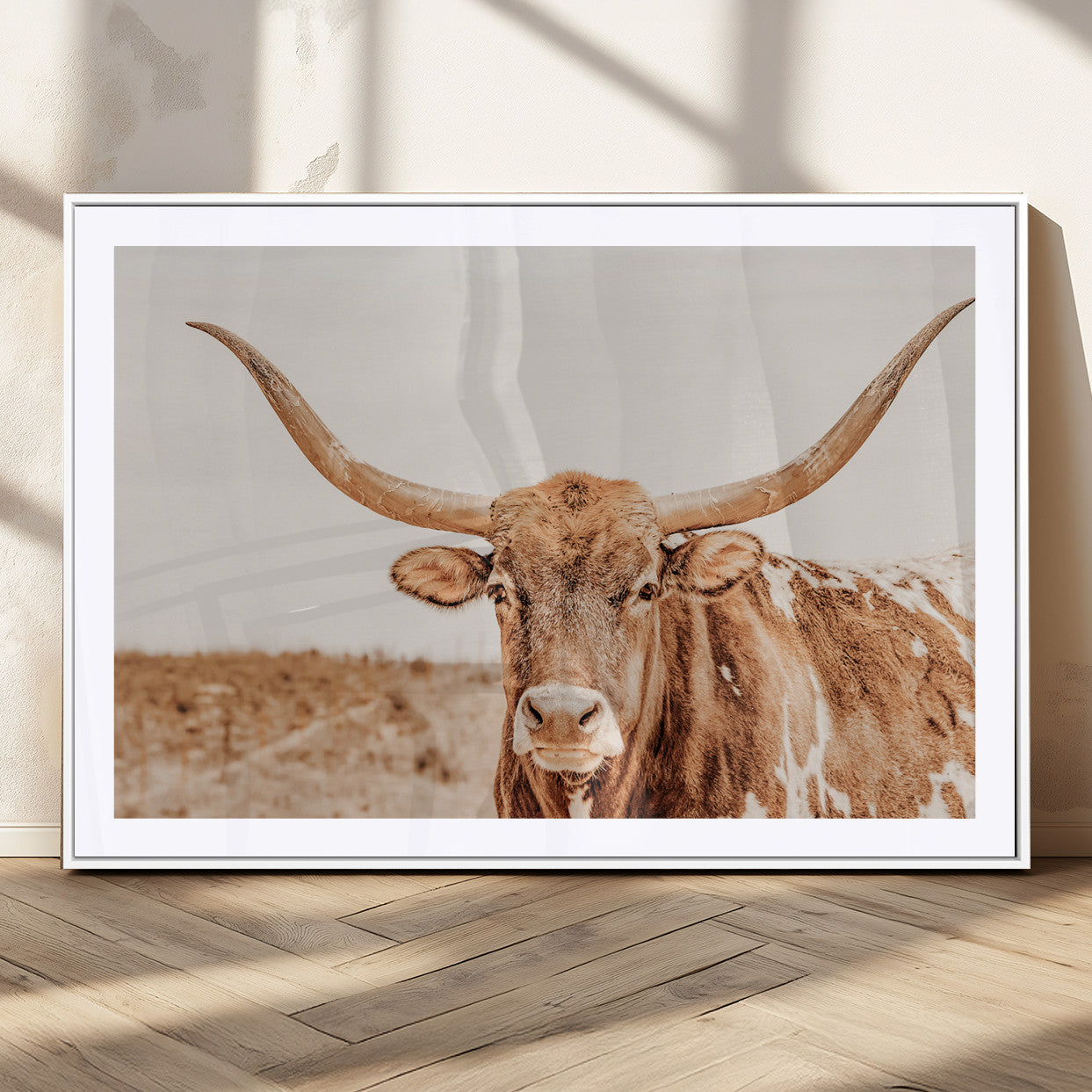 Sepia-toned Texas Longhorn facing forward in a dry field, perfect for rustic farmhouse or western-themed neutral home decor.
