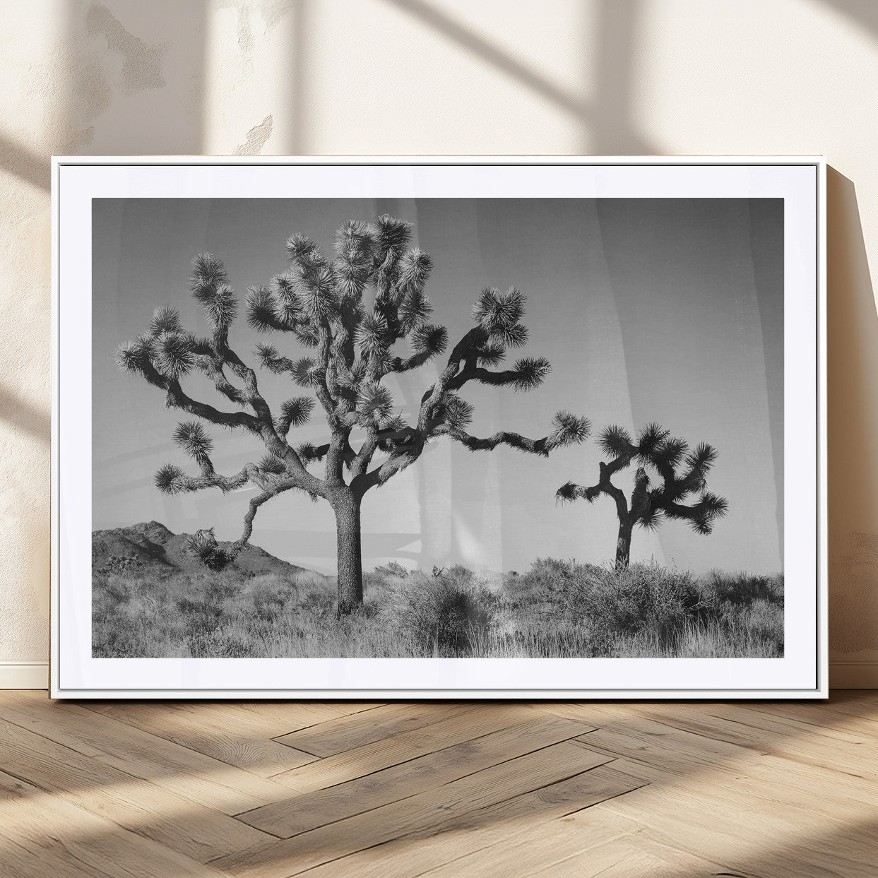Black and white desert scene with two Joshua trees under clear sky, perfect for rustic or boho-inspired home decor.