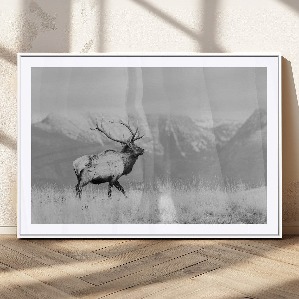 Black and white elk standing in front of snowy mountain range, perfect for rustic lodge or nature-inspired wall decor.
