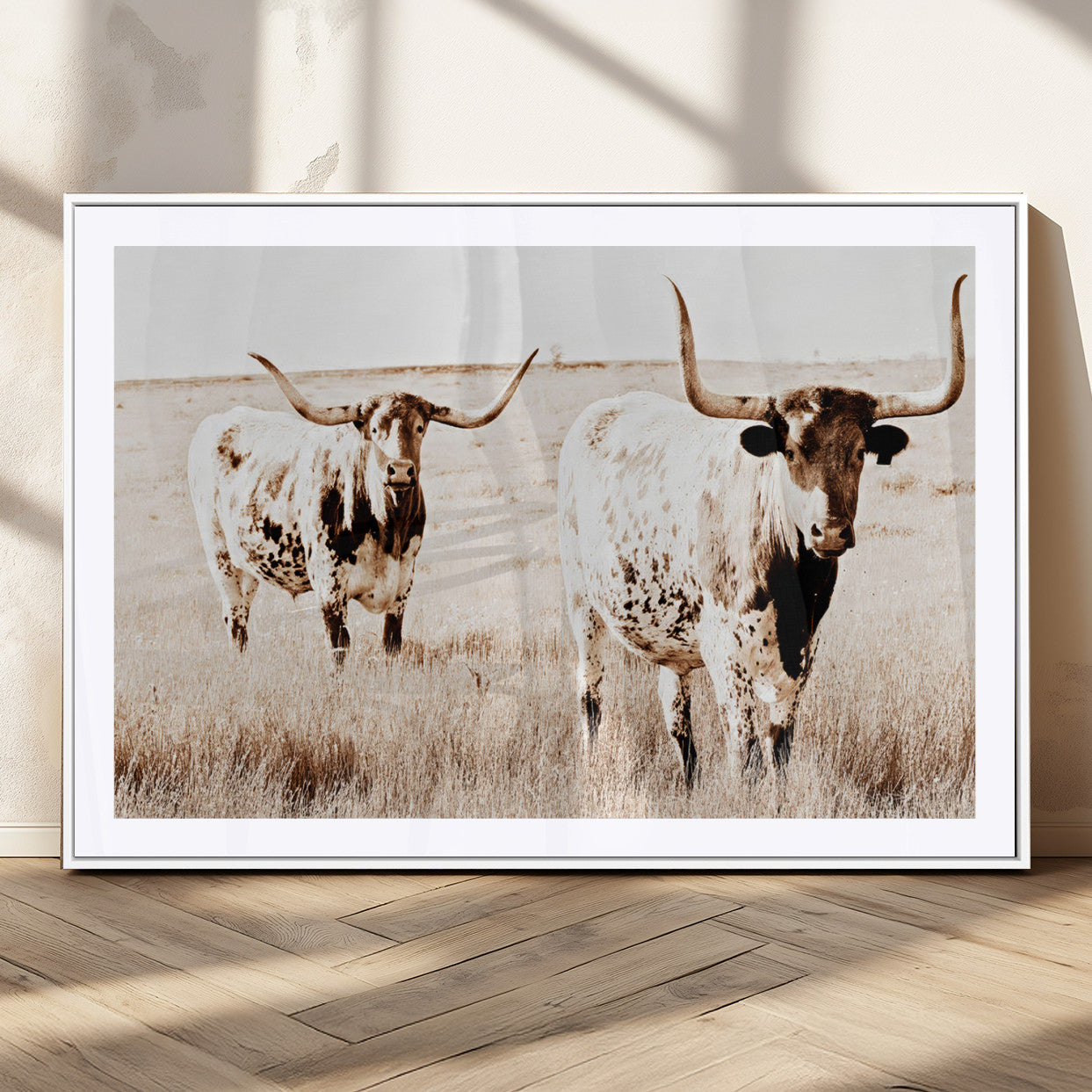 Two Texas longhorn cows standing in a sepia-toned pasture, evoking rustic charm perfect for farmhouse or western country interiors. (