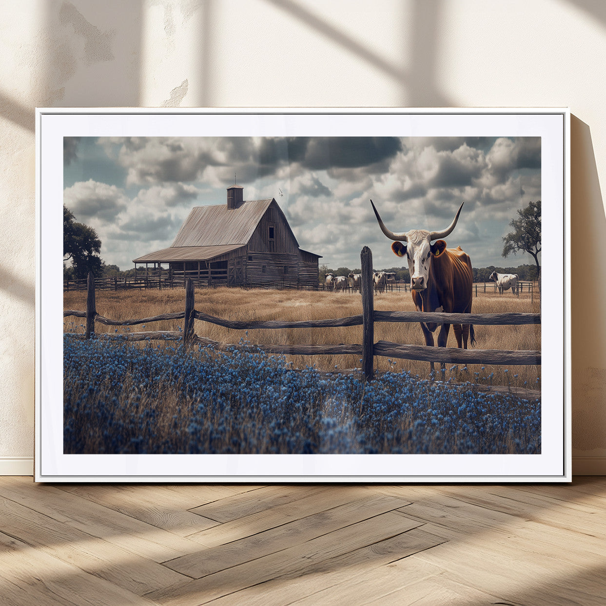 Framed canvas art of a Texas Longhorn cow near a rustic barn and bluebonnet field, ideal for country-style or farmhouse wall decor.