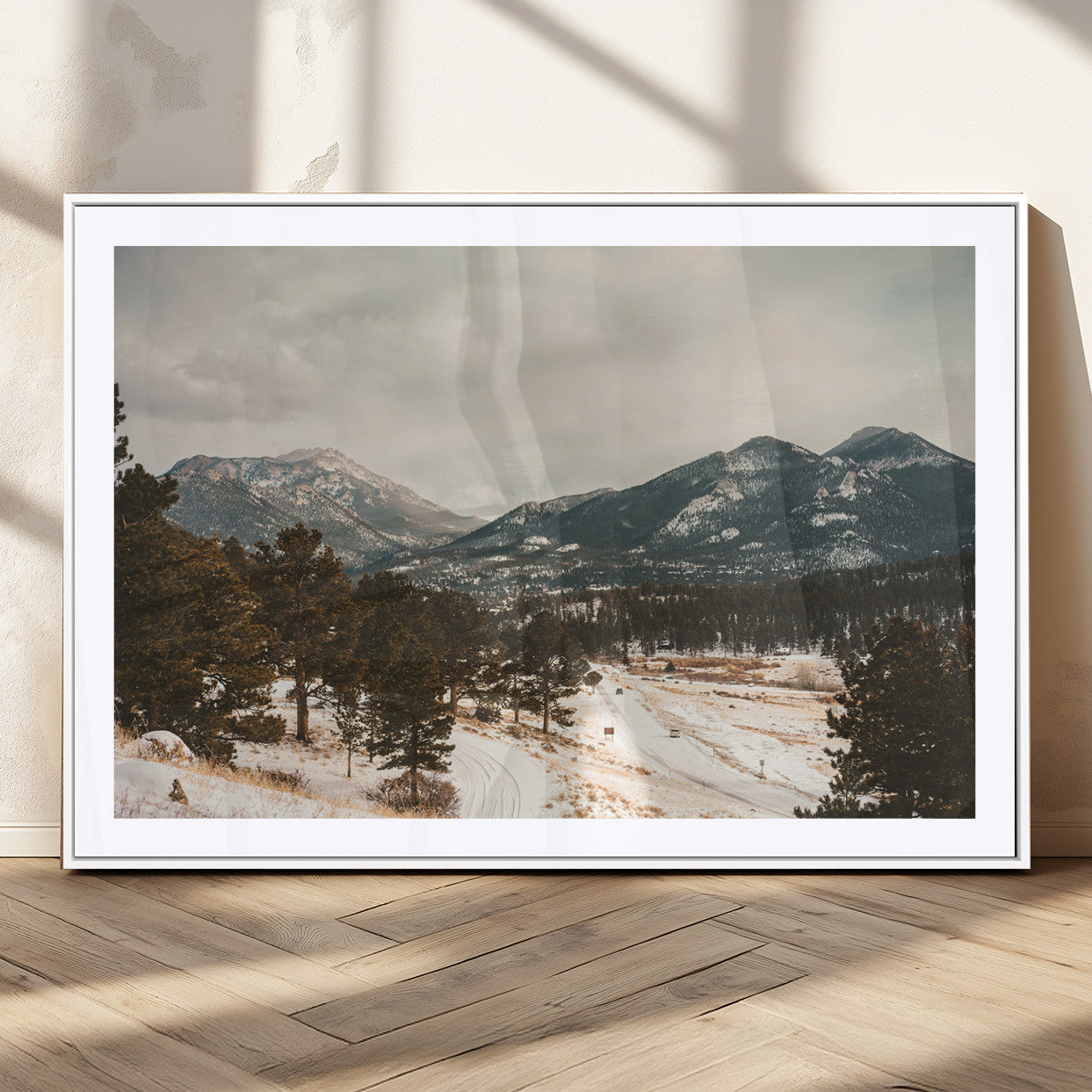 Snow-covered mountains with pine trees and a winding path, creating a serene and rustic winter landscape perfect for cozy decor.