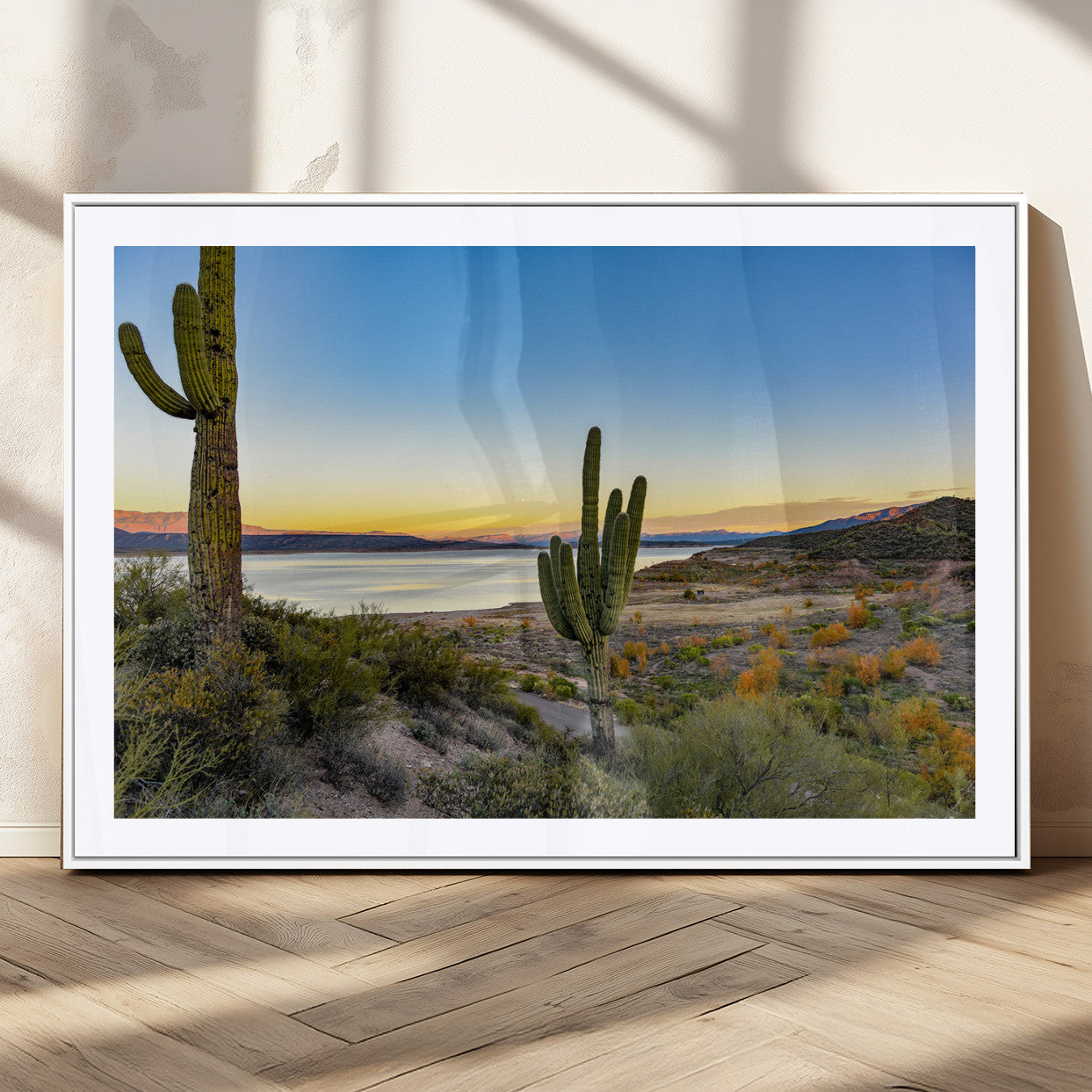 Desert landscape with saguaro cacti and lake at sunset, featuring vibrant sky and hills, ideal for Southwestern or rustic wall decor.