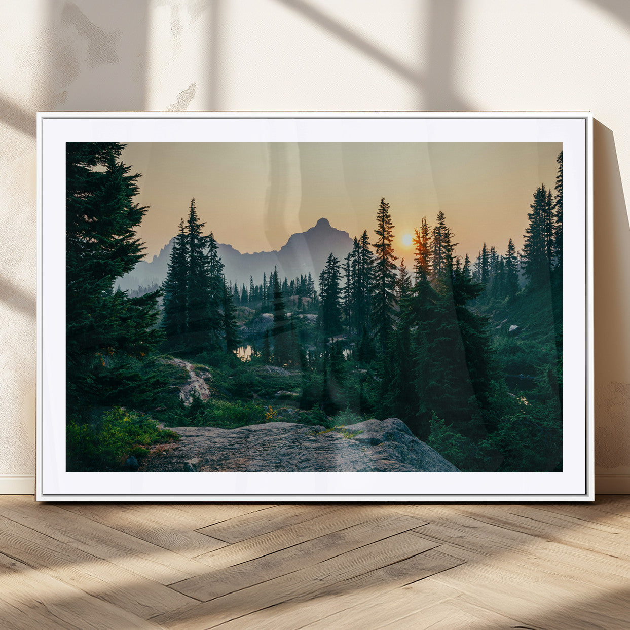 Mountain landscape with evergreen trees at sunset, casting a golden glow over the wilderness, creating a peaceful and rustic nature scene.