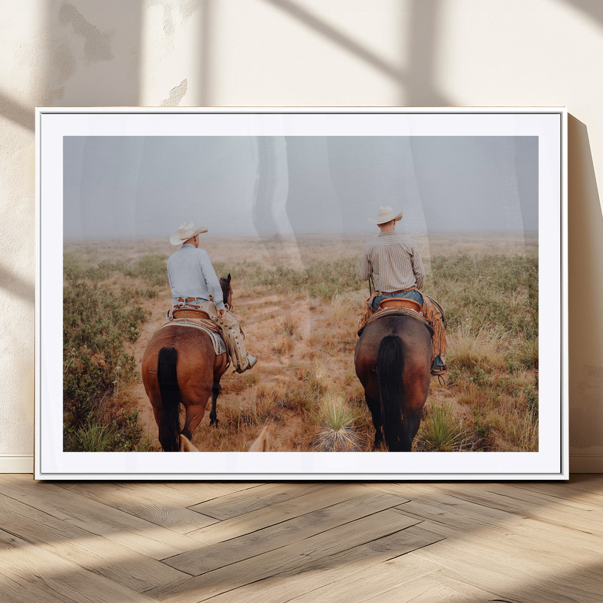Two cowboys riding horseback through a misty prairie, capturing the rustic and adventurous spirit of the Western frontier.