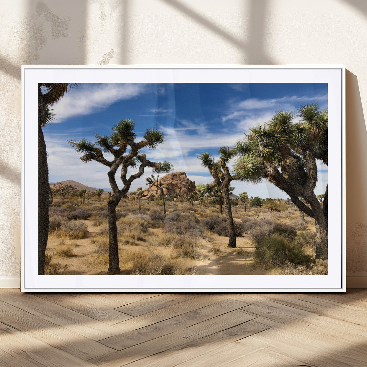 Scenic Joshua Tree landscape with rugged desert terrain, golden dry grass, and a deep blue sky, creating a warm, rustic Southwestern aesthetic.