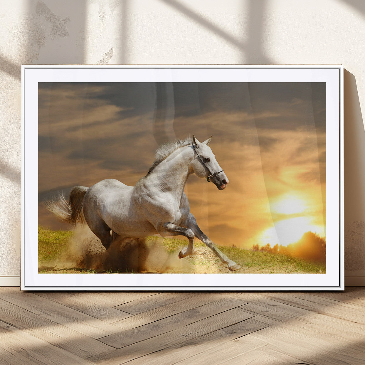 A powerful white horse galloping through the field at sunset, with the golden light illuminating its mane and the vibrant sky in the background.