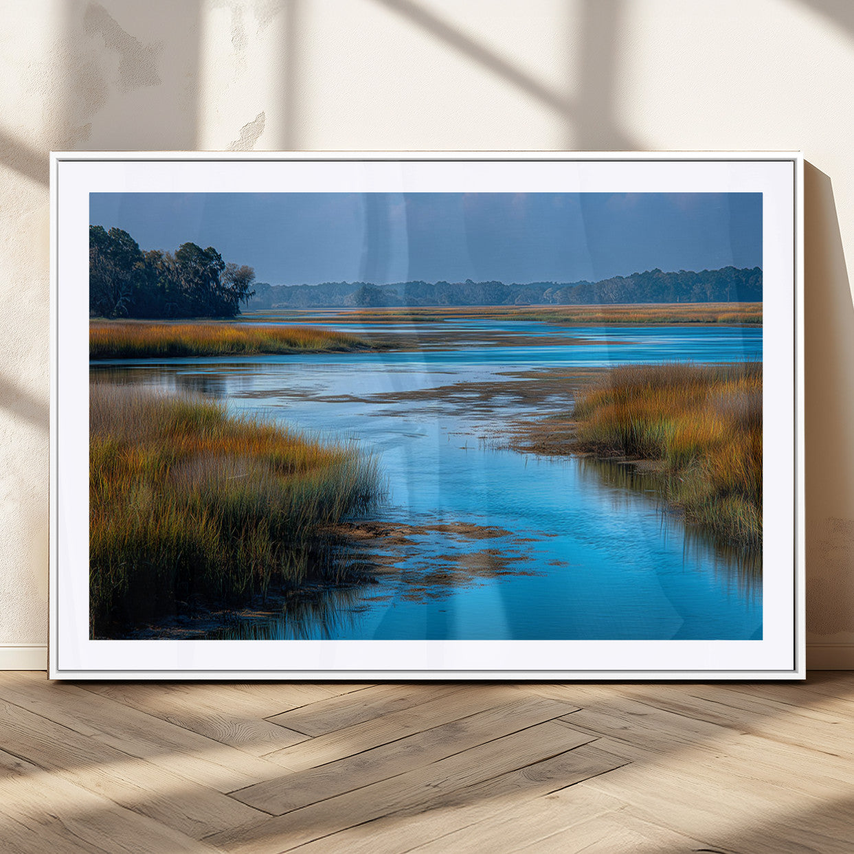 A peaceful marshland scene with calm blue water reflecting the surrounding grasses and trees, capturing the beauty of nature in a serene landscape.