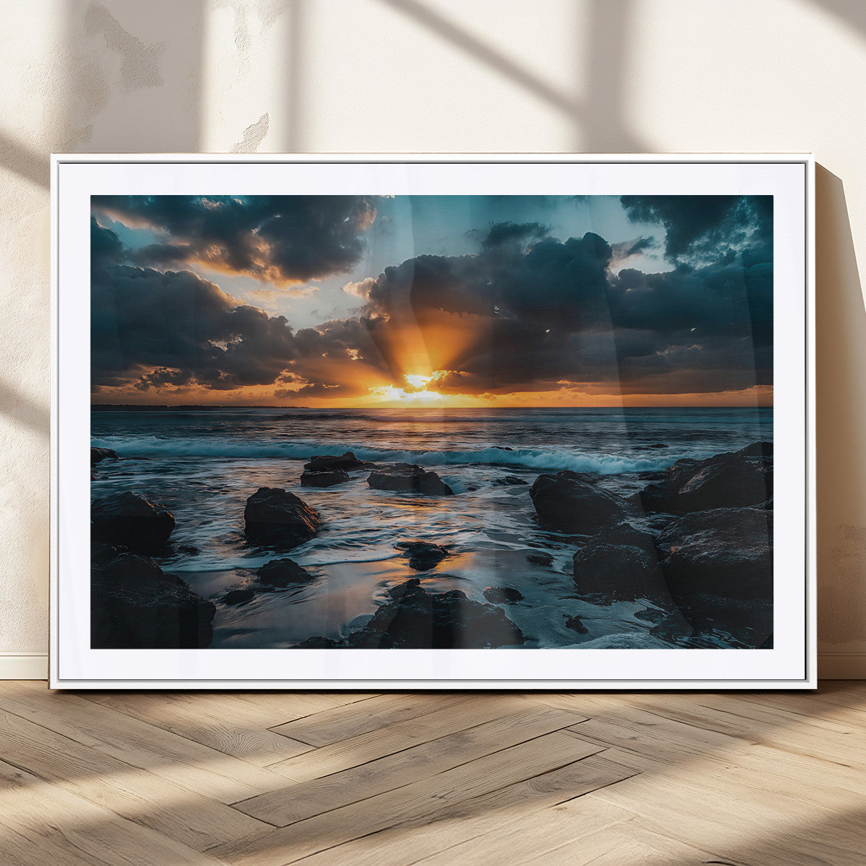 An awe-inspiring sunset over the ocean with rays of light piercing through dramatic clouds, creating a beautiful seascape with rocks in the foreground.