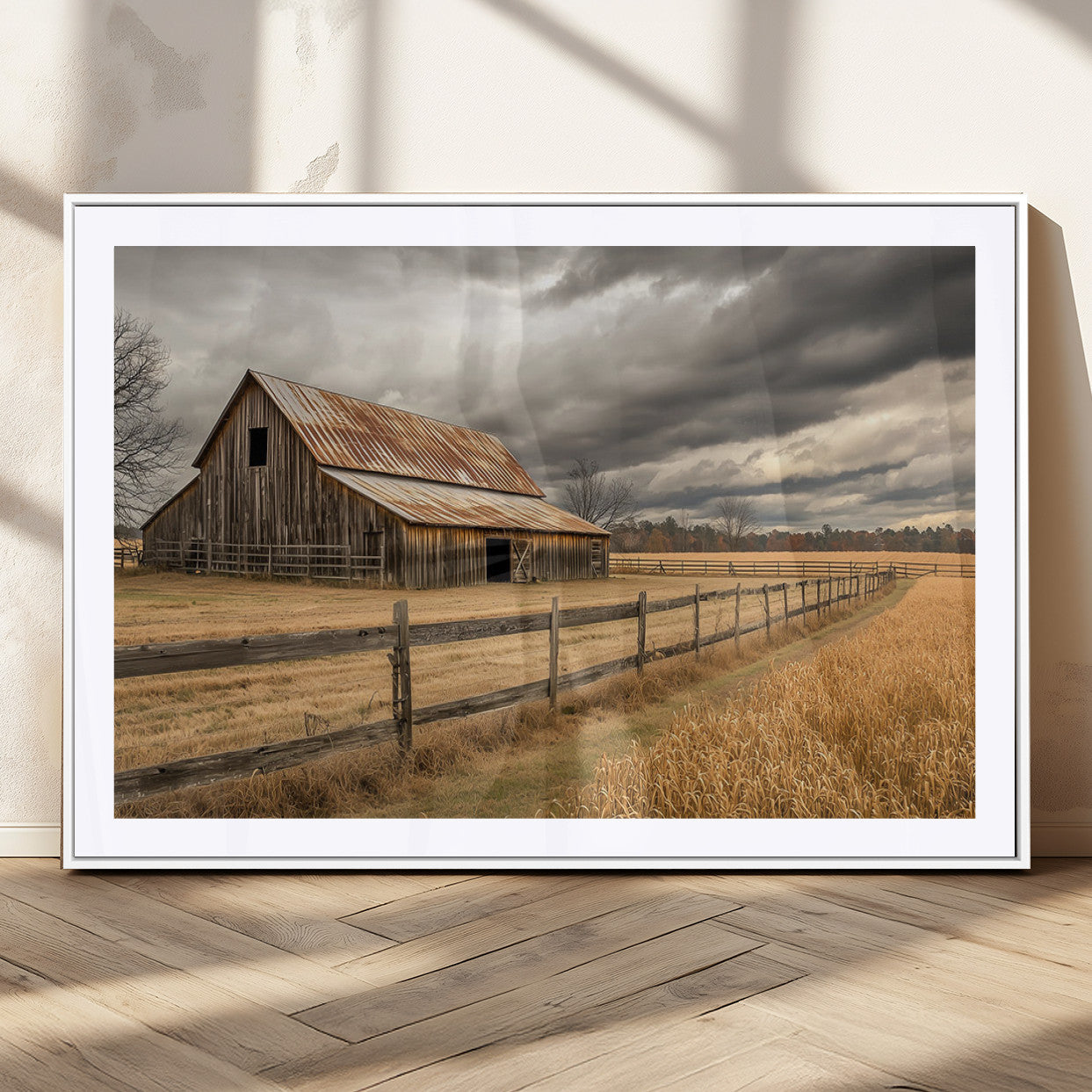 "Rustic barn with a weathered metal roof, surrounded by a wooden fence and golden fields under an overcast sky with dramatic clouds."