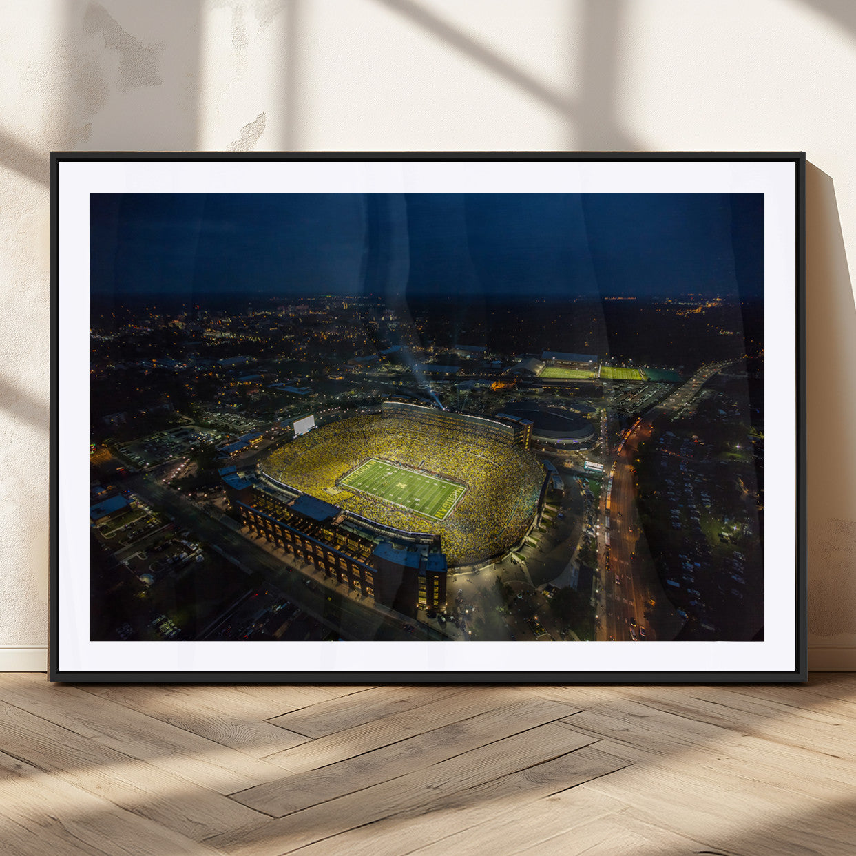 33588-MGC-FP-36x24_Black-Michigan Stadium Night Game Wall Art – Sports Arena Aerial View Canvas Print, Framed, Ready to Hang